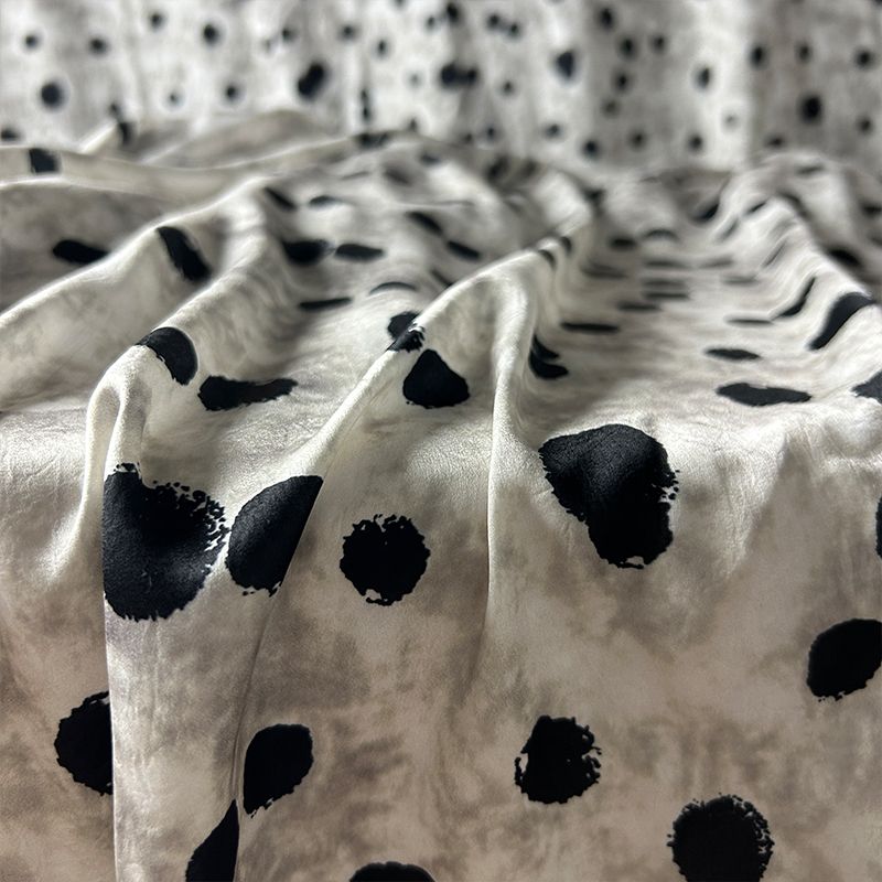 This fabric features a soft and drape design with a stir-fried grey base, slightly wrinkled satin finish, and irregular large polka dot printed acetate fabric Specification image