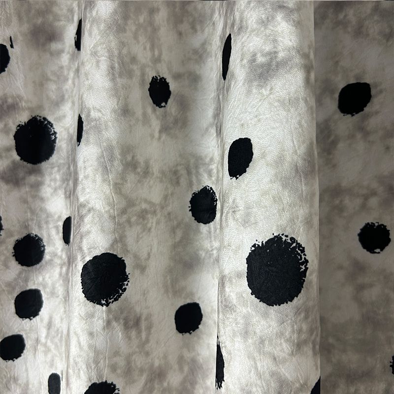 This fabric features a soft and drape design with a stir-fried grey base, slightly wrinkled satin finish, and irregular large polka dot printed acetate fabric Application Scenario