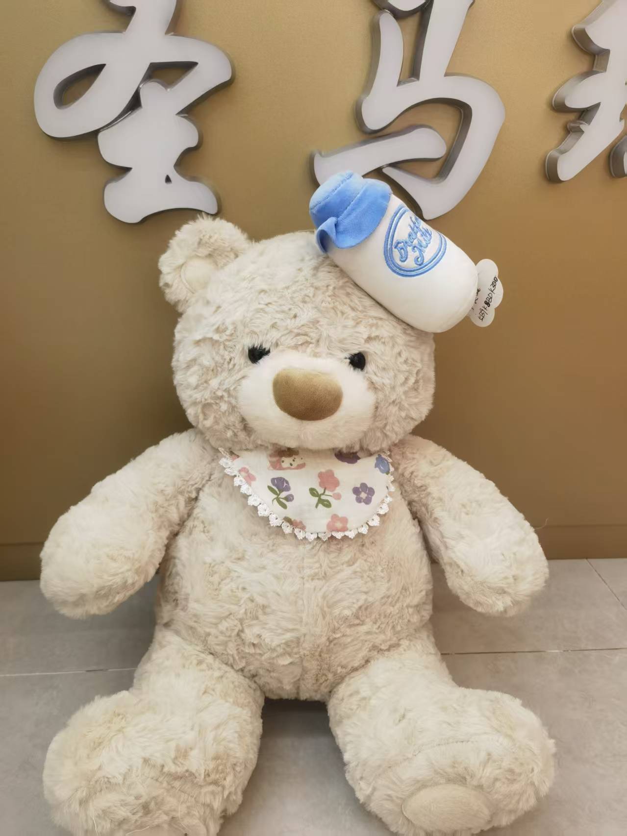 A 38CM cute bear wearing a baby bottle, adorable and cute! Heartwarming plush toys