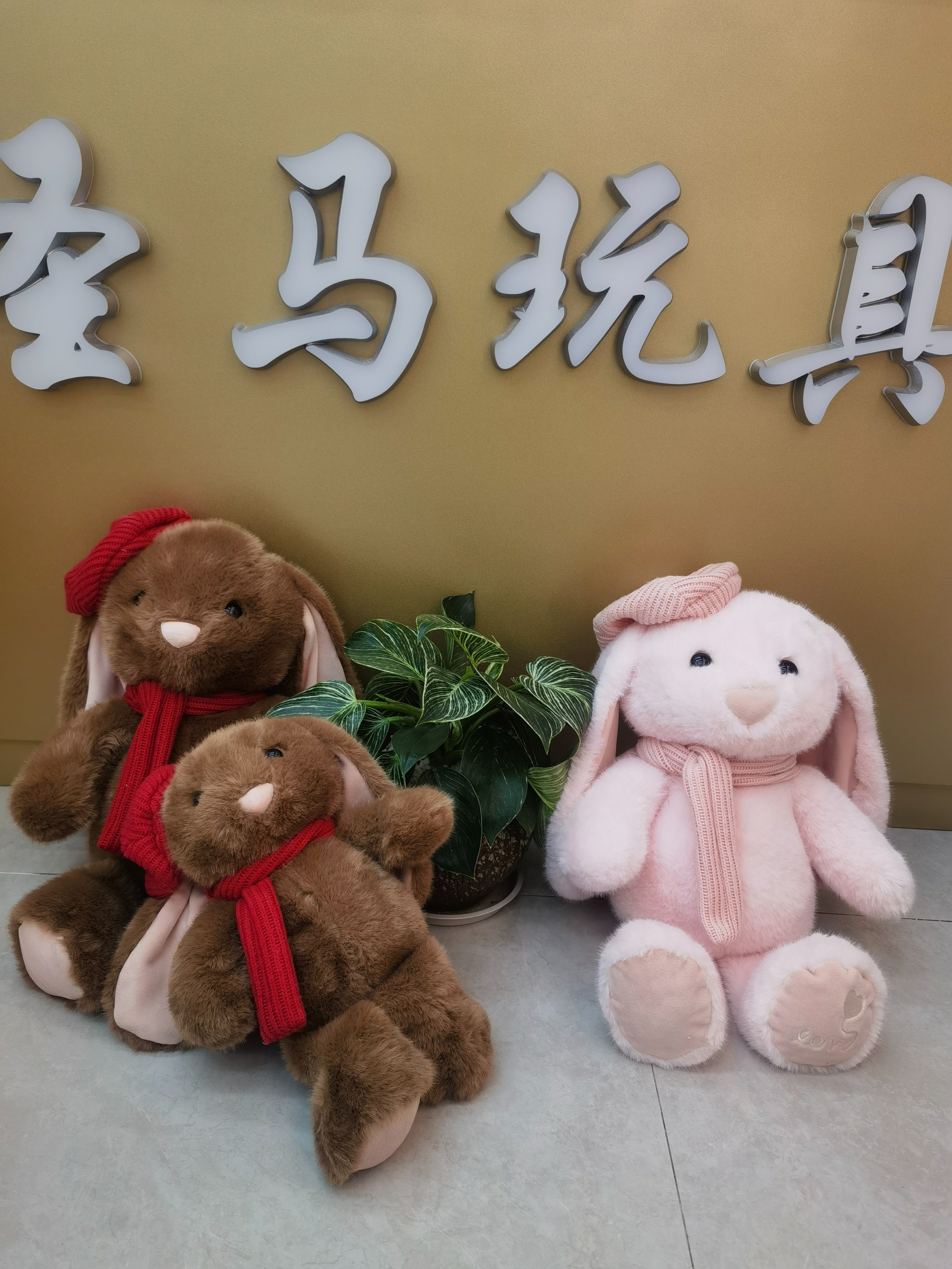 A 35CM cute rabbit wearing a red scarf and accompanied by green plants, warm and adorable. Application Scenario