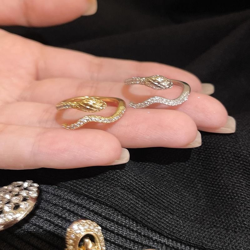 A new, versatile and unique open-mouted index finger ring with a full diamond snake-shaped design for women