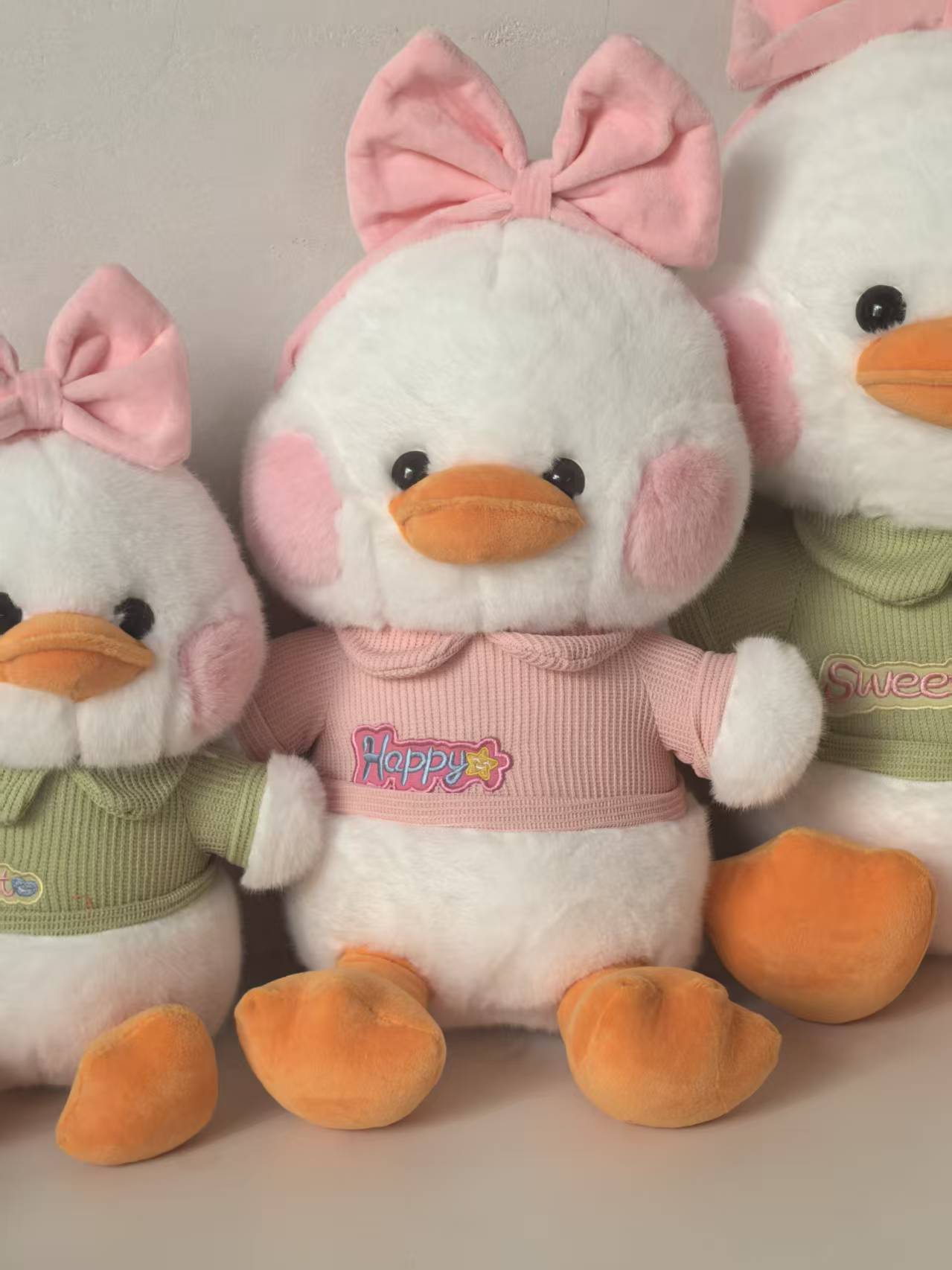 Cute plush toy figurines of hugging ducks