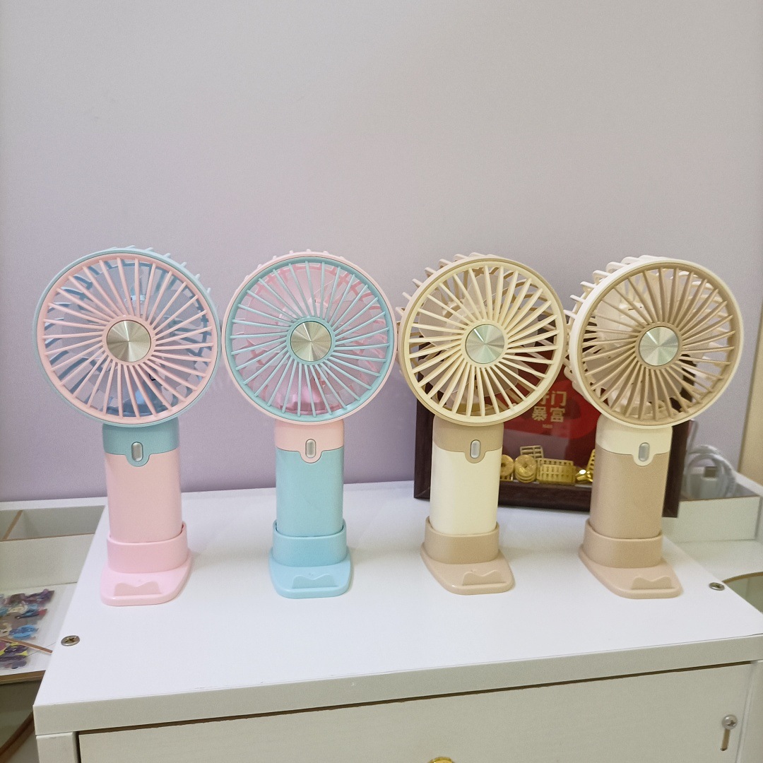 The new simple and mini handheld fan has a strong wind force and can be charged by USB. It is a portable desktop stand for outdoor students thumbnail