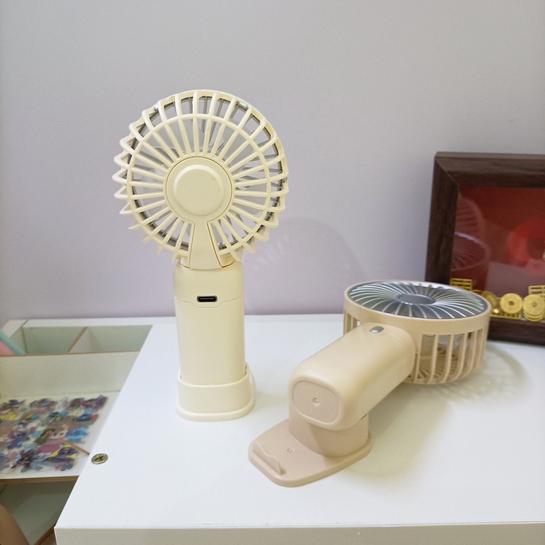 The new simple and mini handheld fan has a strong wind force and can be charged by USB. It is a portable desktop stand for outdoor students full figure