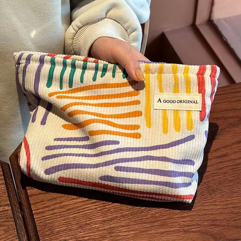 ins niche corduroy contrast color striped make-up bag portable travel travel skin care products buggy bag wash bag details Picture