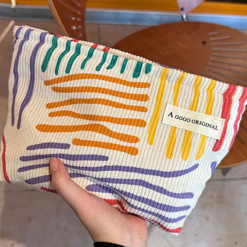 ins niche corduroy contrast color striped make-up bag portable travel travel skin care products buggy bag wash bag Application Scenario