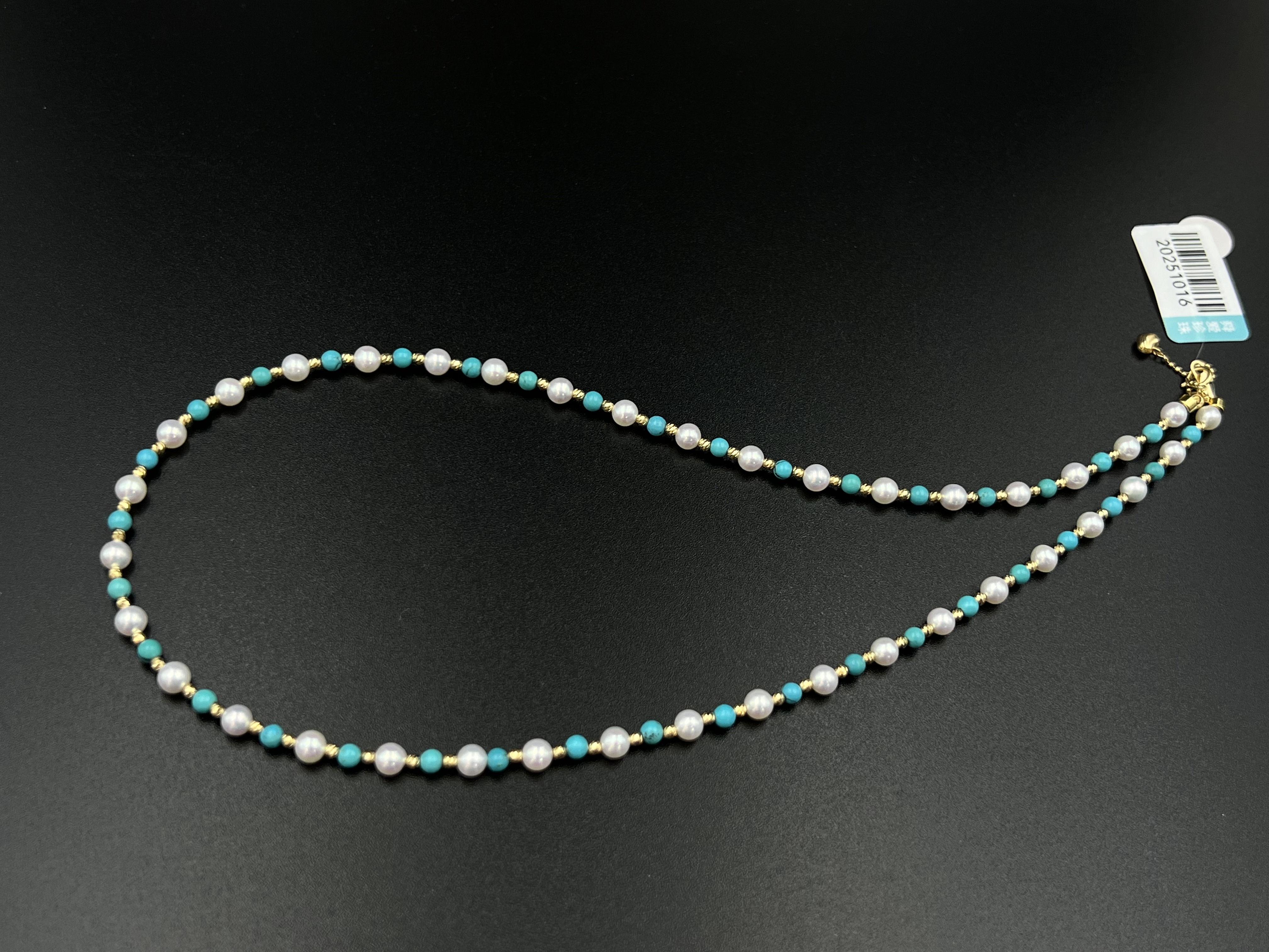 An 18K gold natural pearl necklace paired with turquoise detail image 2