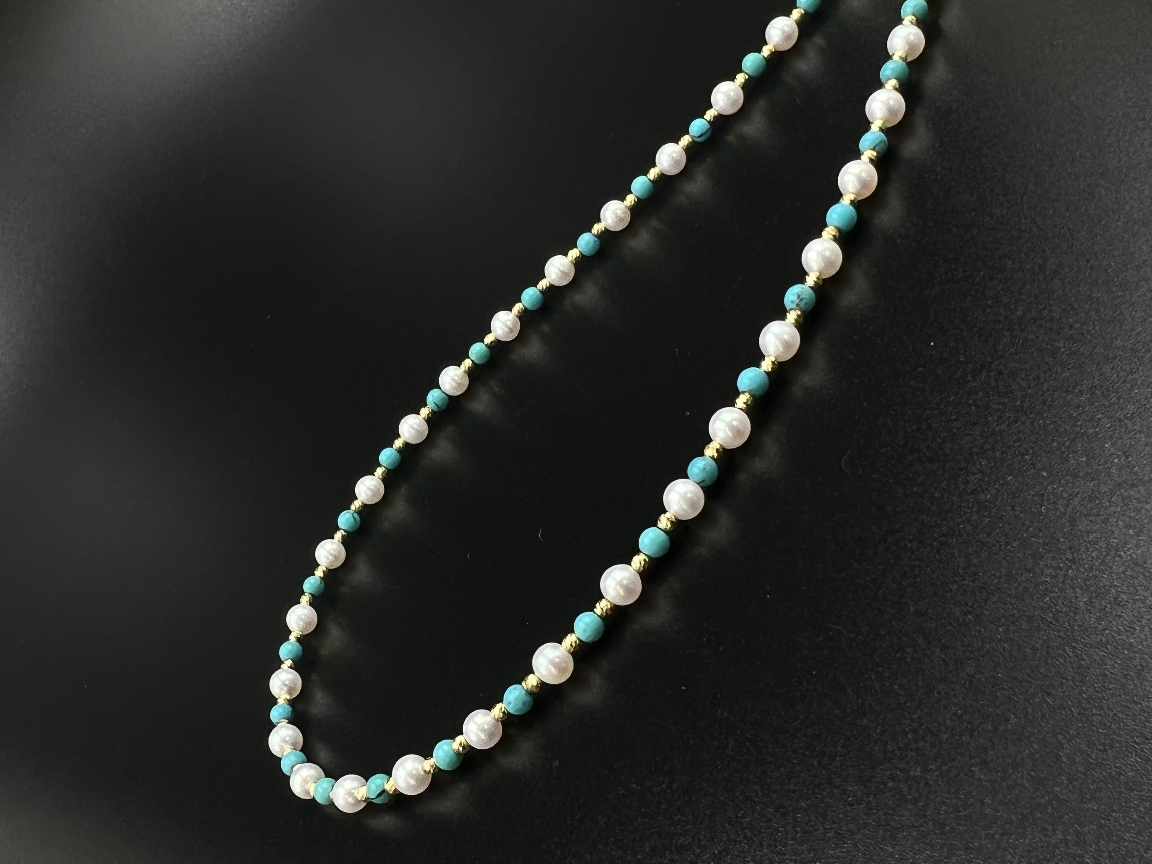 An 18K gold natural pearl necklace paired with turquoise detail image 3