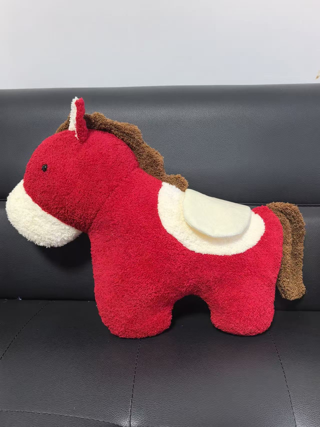 Red plush horse doll rocking horse, leather figure of the horse zodiac sign in the Year of the Horse, carousel