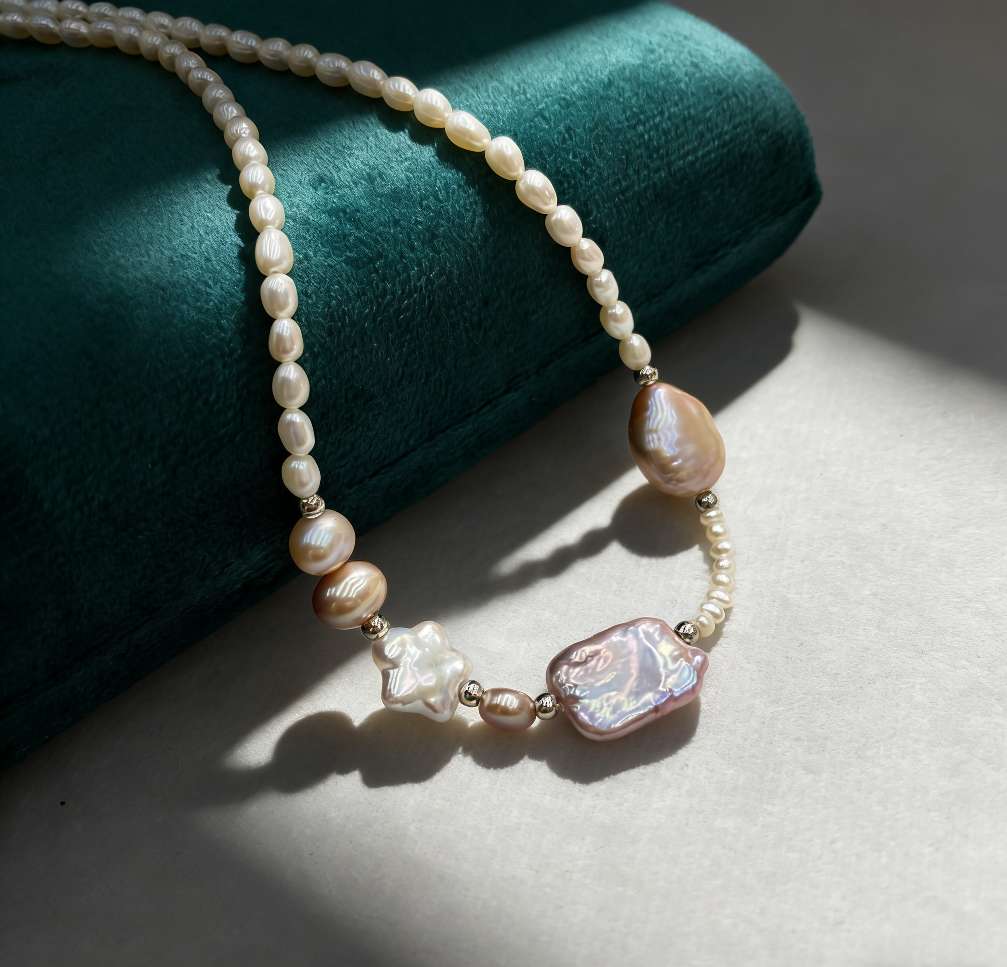 The 2026 new style of Starlight Pink Jade Natural freshwater pearl Baroque necklace features an irregular pinkish-purple gradient design and a light luxury niche collarbone chain. It is a 925 sterling silver tail chain