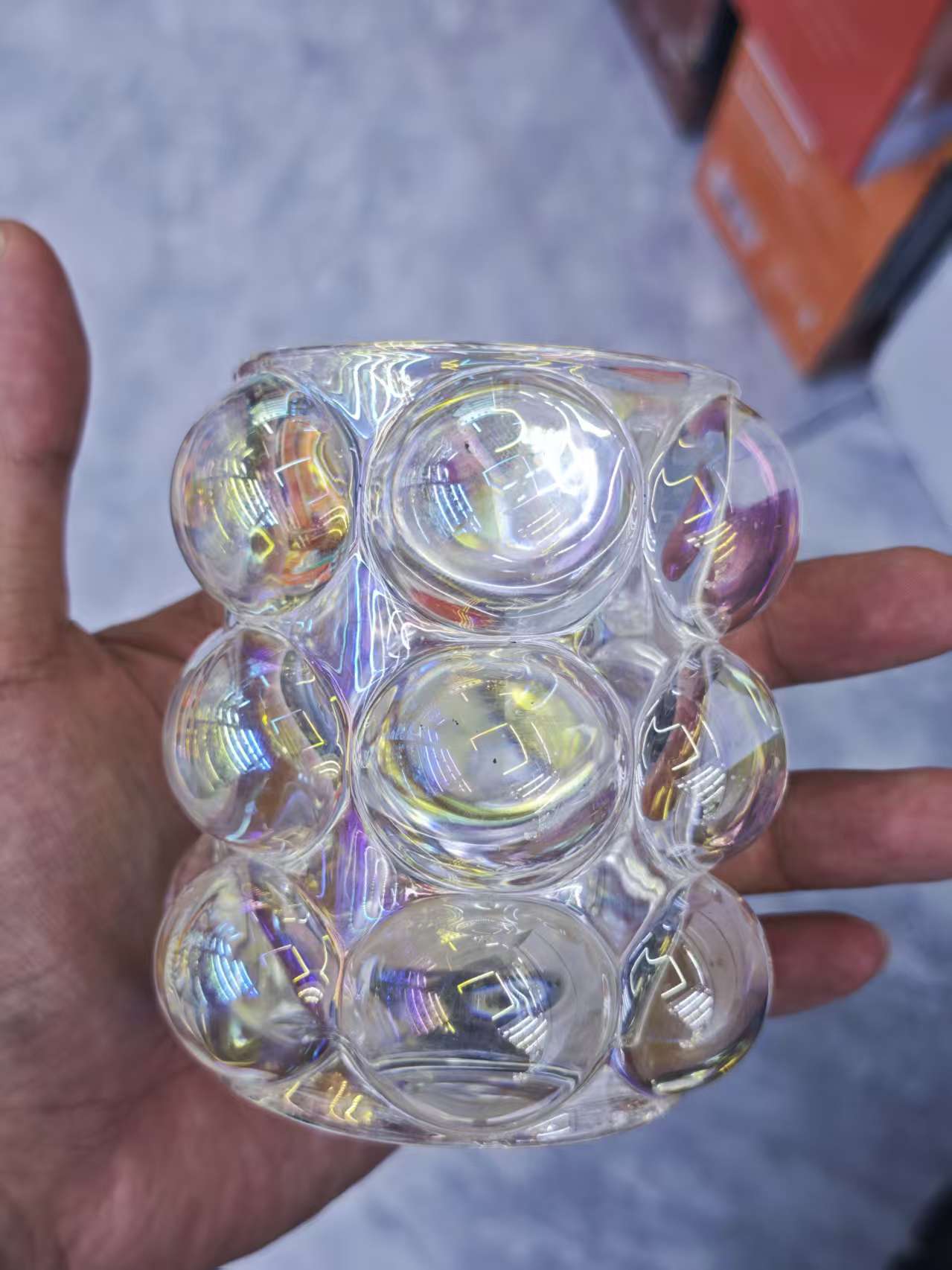 The transparent water cup is surrounded by colored glass balls details Picture