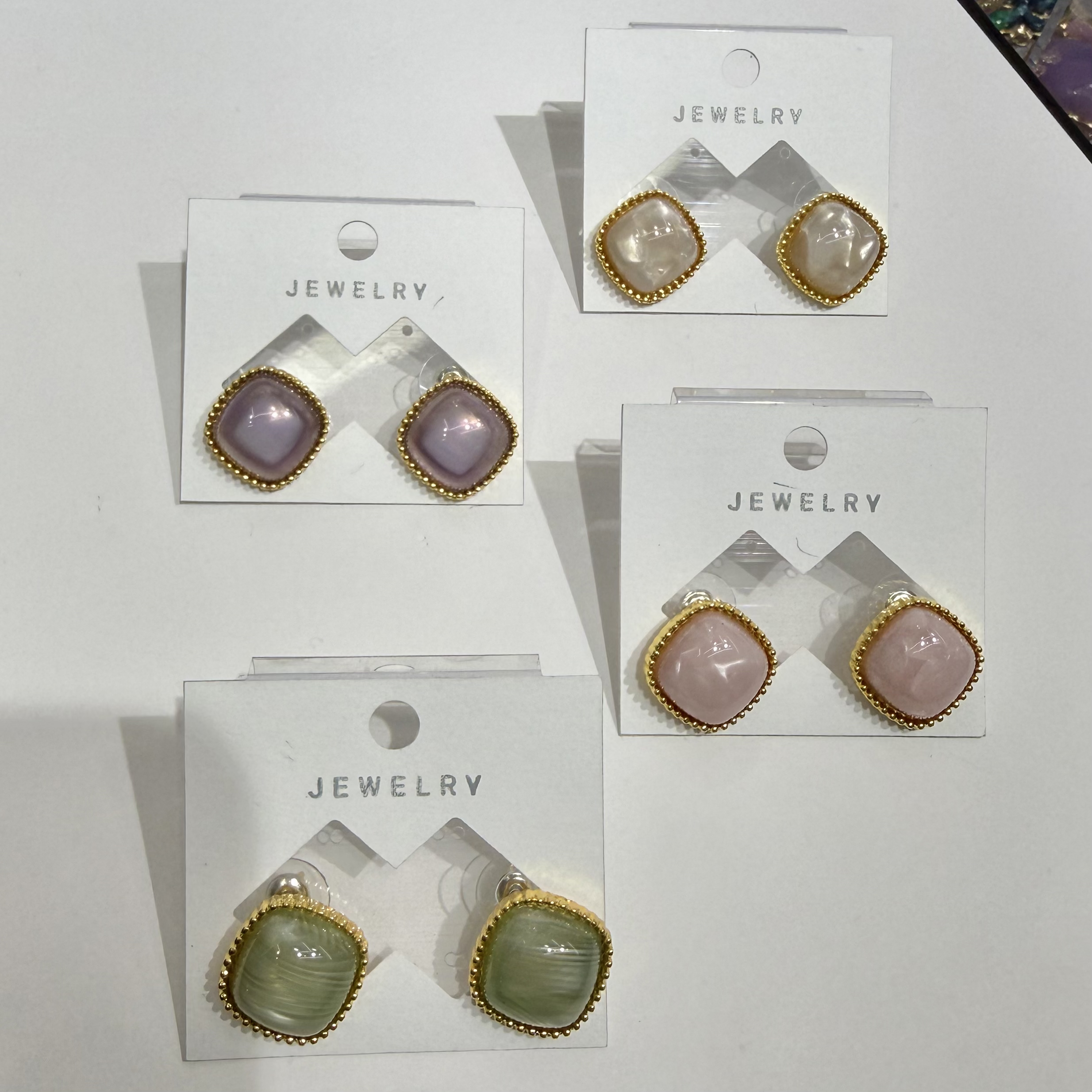 Four pairs of fashionable square gemstone earrings with light purple, light pink, light green, beige and gold borders as JEWELRY accessories