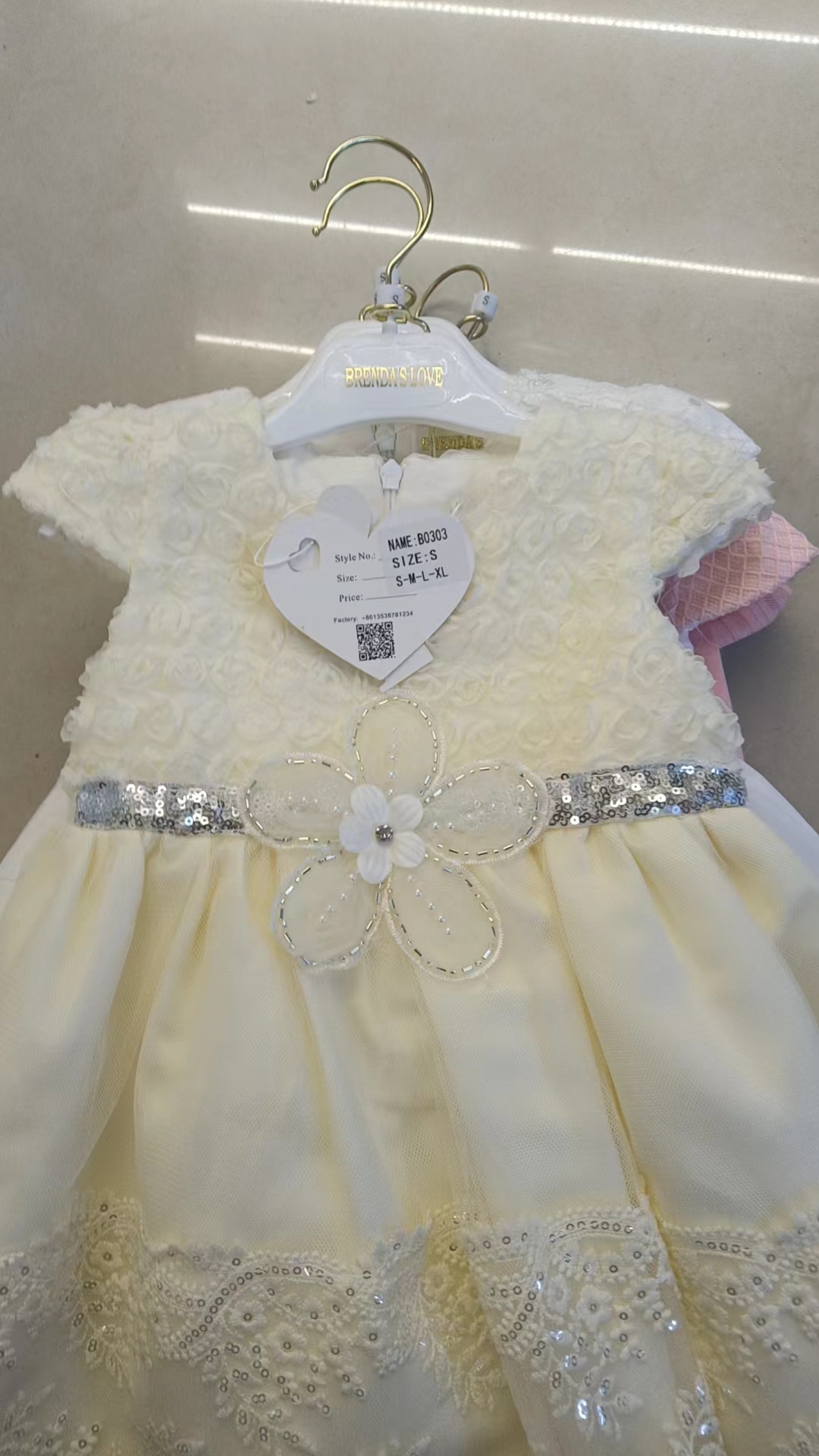 A pink, green and yellow multi-layered ruffled dress paired with white pants, a sweet and cool children's dress for young kids, and linen birthday supplies Item Picture