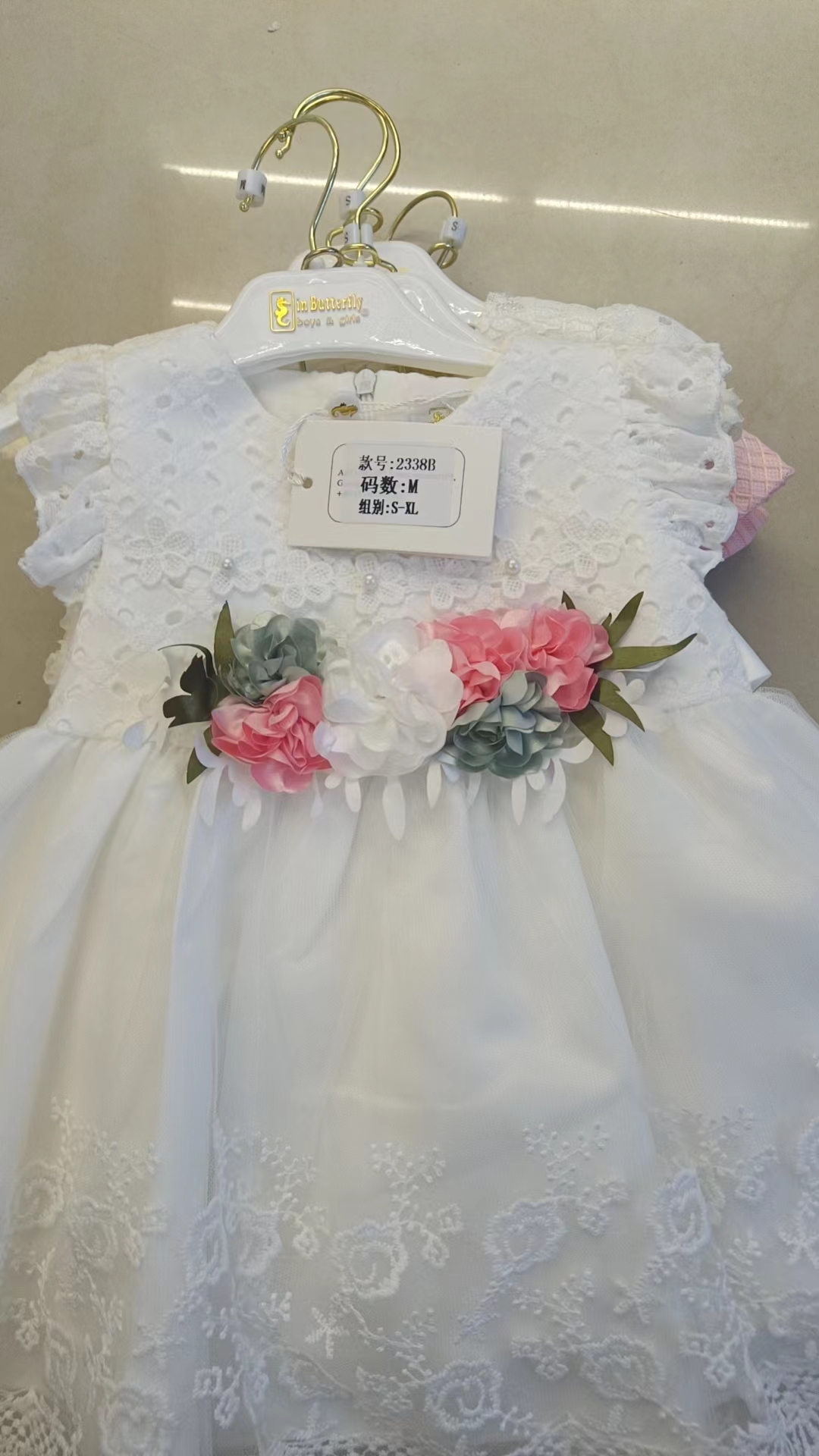 A pink, green and yellow multi-layered ruffled dress paired with white pants, a sweet and cool children's dress for young kids, and linen birthday supplies Specification image