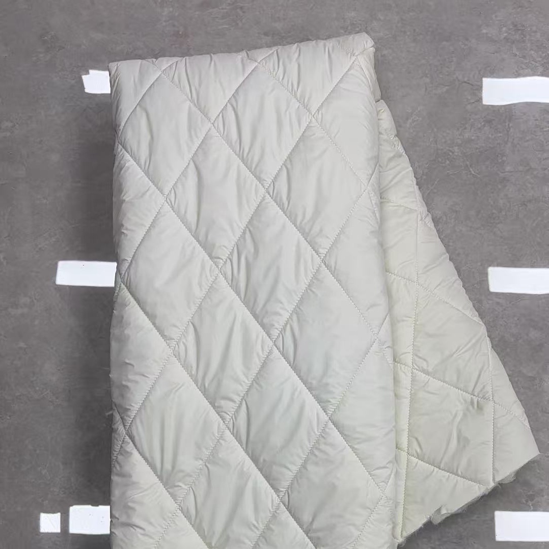 Quilted fabric in warm white