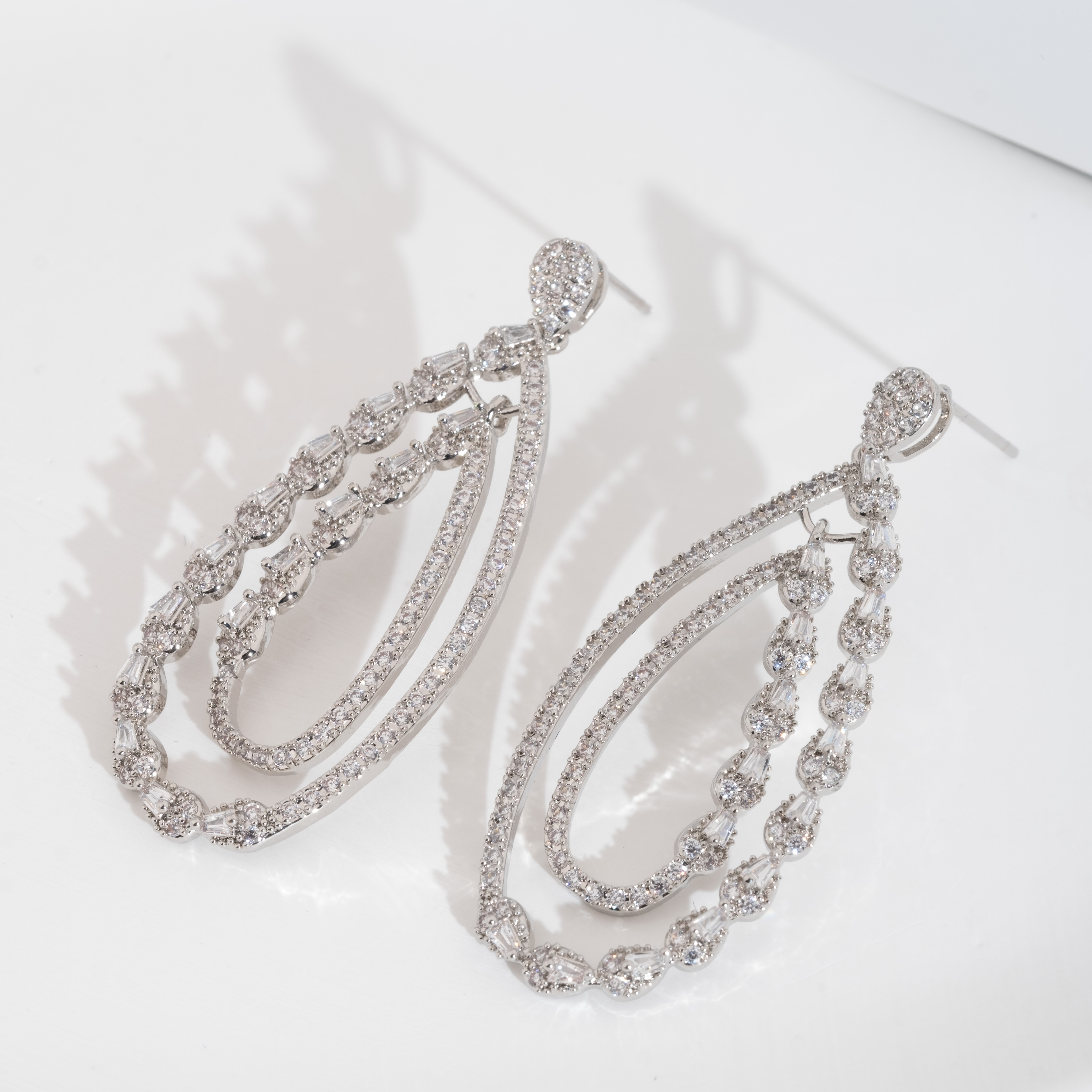 A set of luxurious earrings with a sparkling cubic zirconia hollowed-out teardrop design is suitable for ladies to wear at their weddings Specification image