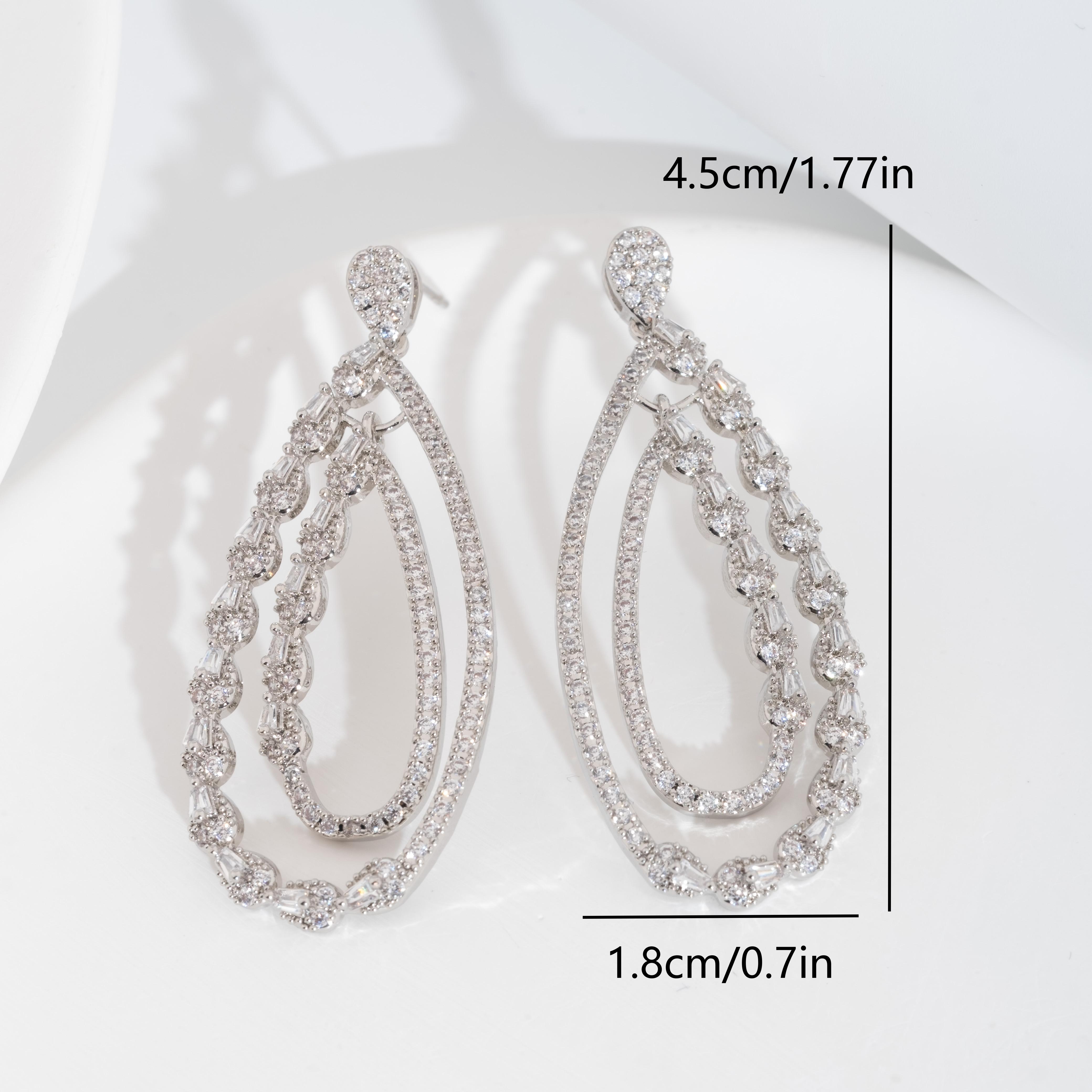 A set of luxurious earrings with a sparkling cubic zirconia hollowed-out teardrop design is suitable for ladies to wear at their weddings Item Picture