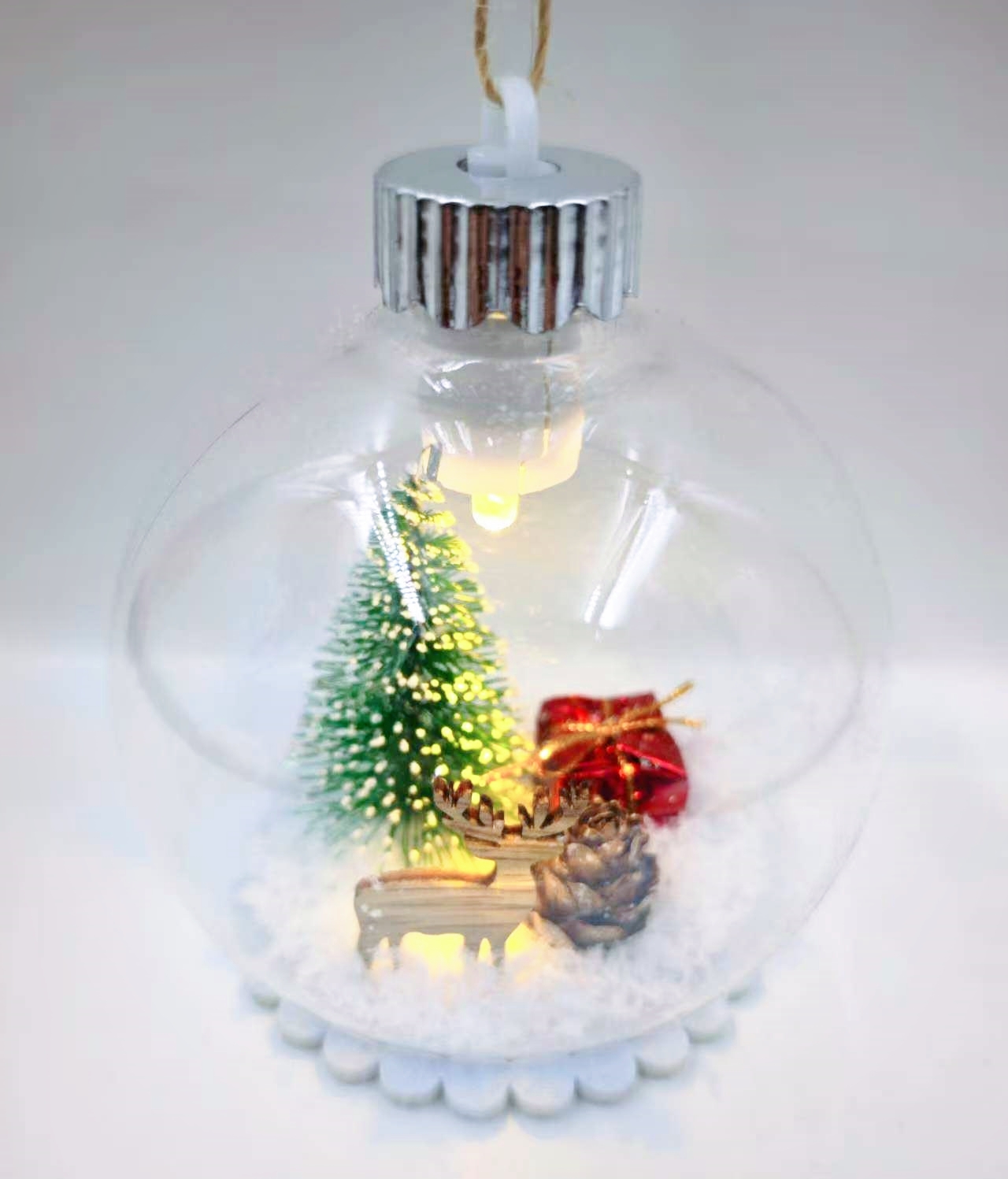 A 10CM plastic transparent snow scene Christmas ball with a light