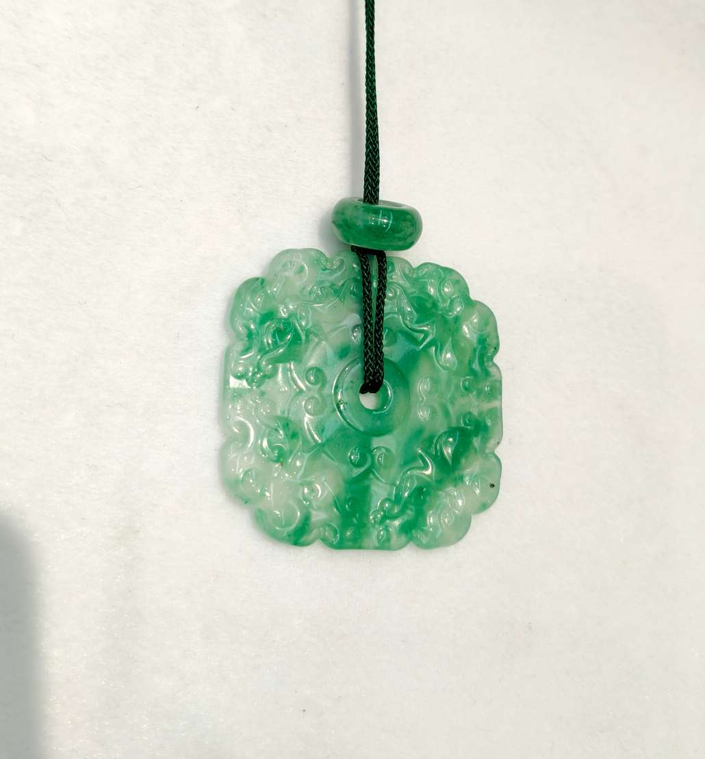 The jade pendant in the misty rain is made of natural jade from Africa, symbolizing wealth from all directions
