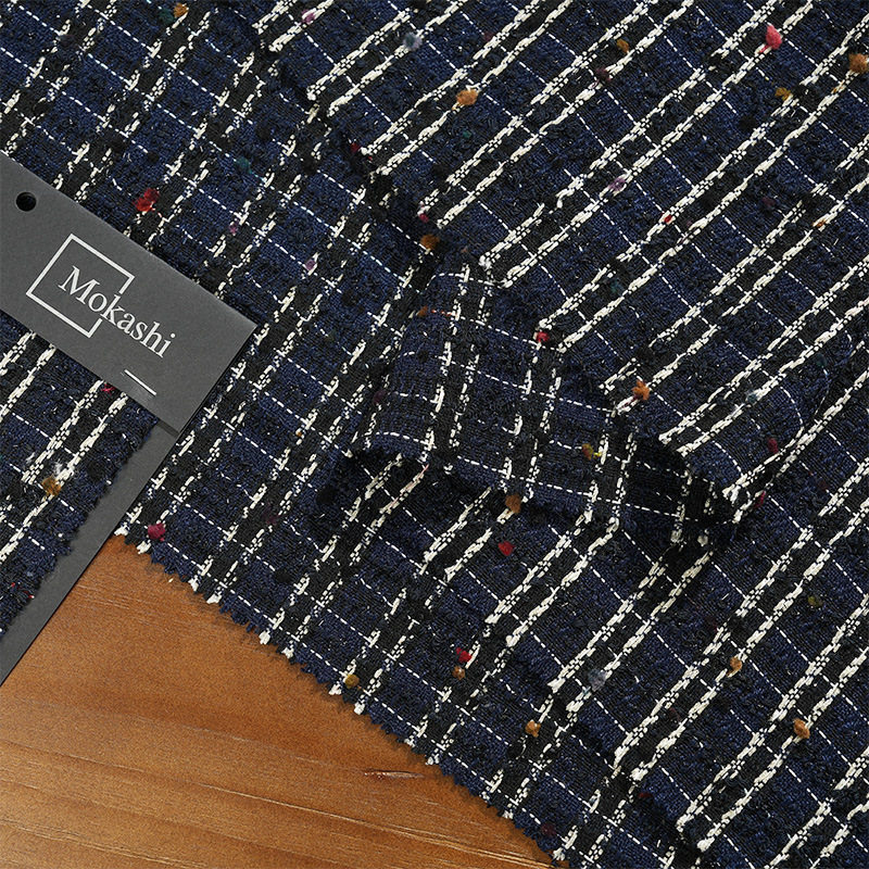 Mokas' little Champs-style fabric features checkered woven colorful balls blended with coarse wool
