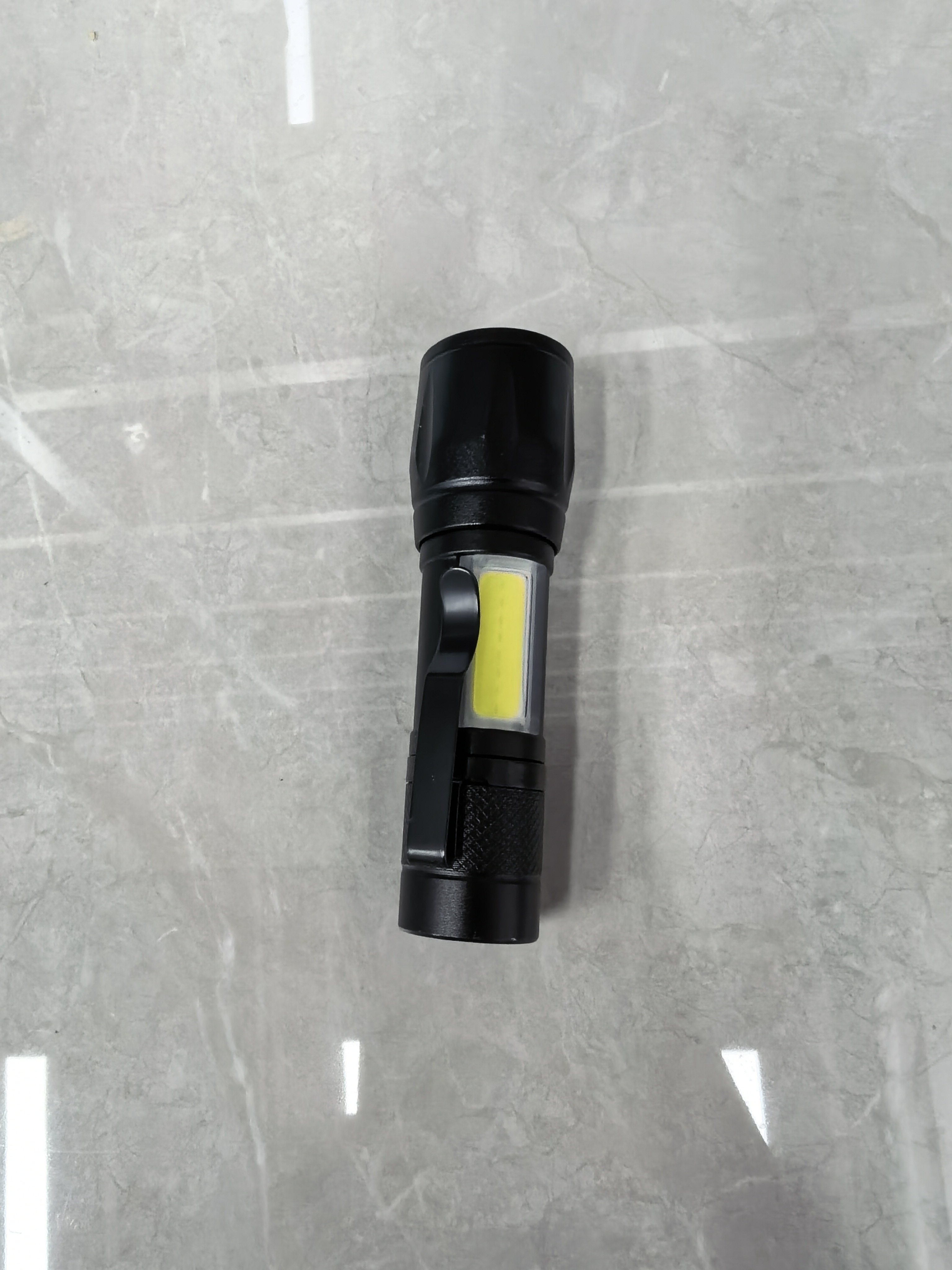 A small flashlight with built-in battery charging details Picture