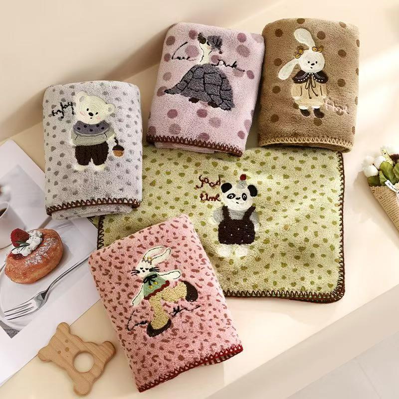 The coral fleece bath towel is made of polyester fabric and features a variety of water-absorbing cartoon patterns