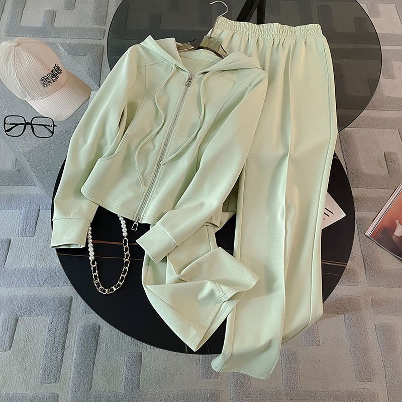 A fashionable and casual women's sportswear set with a white and beige hooded zipper jacket and casual sweatpants full figure