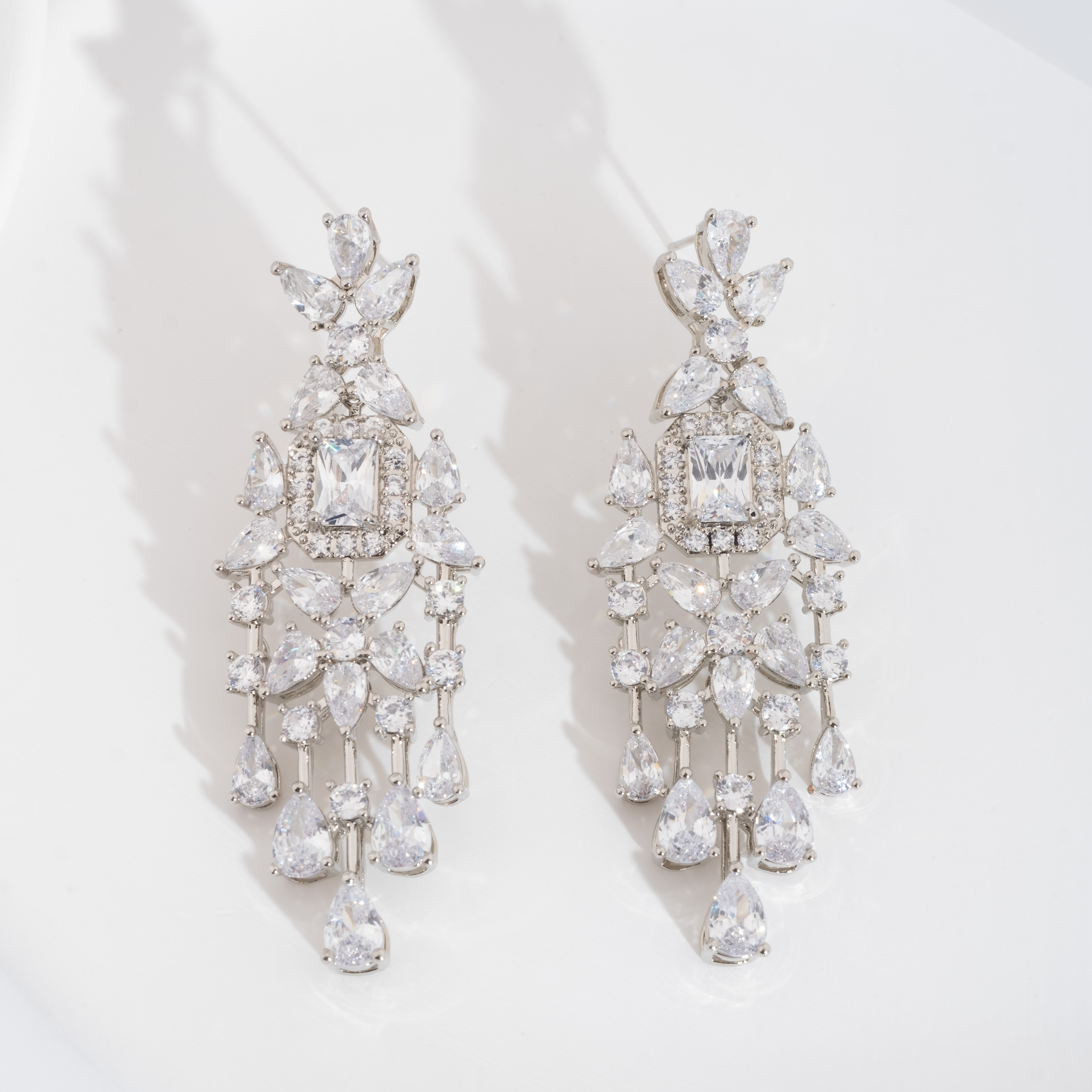 A set of luxurious and elegant earrings with a sparkling cubic zirconia bouquet design is suitable for ladies to wear at a wedding