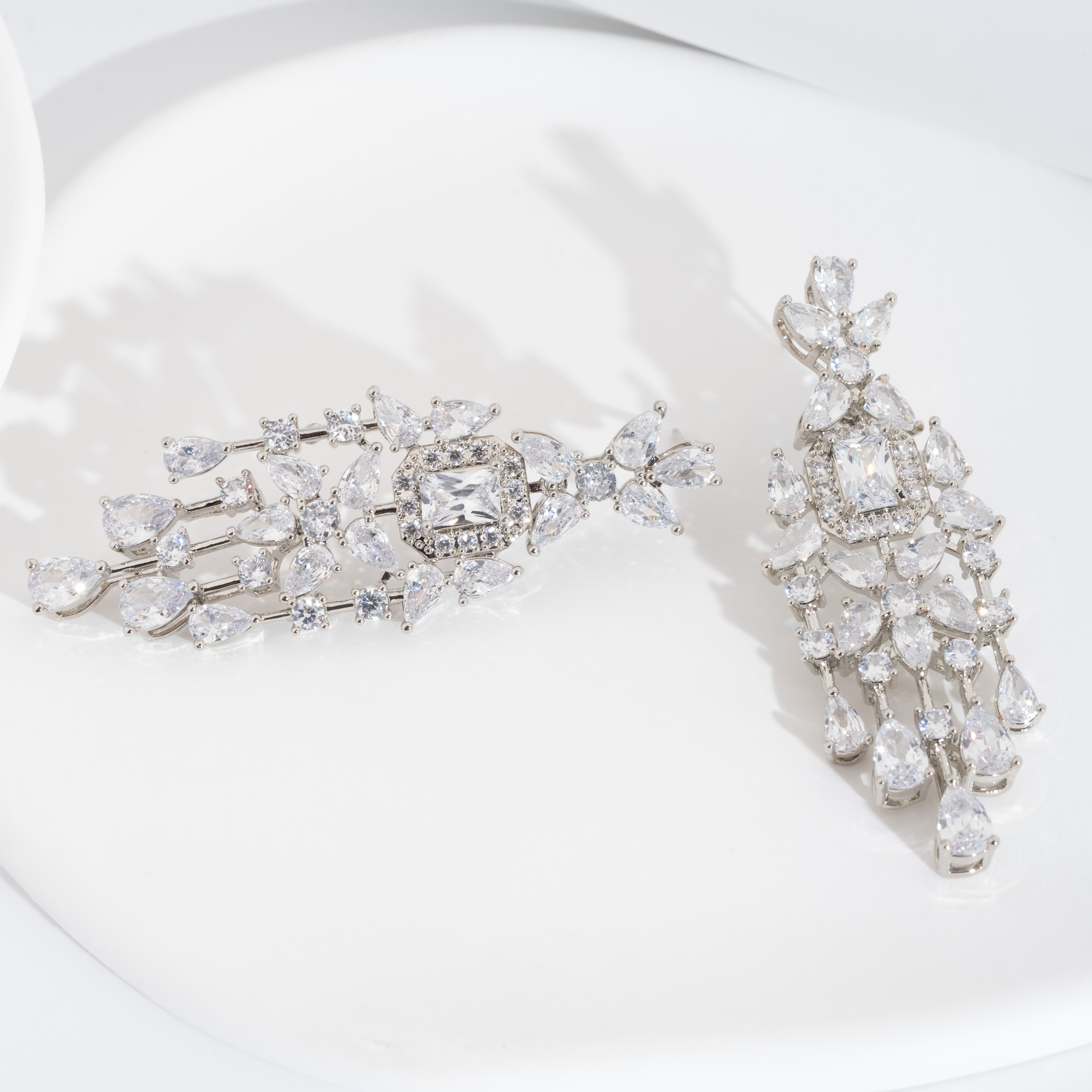 A set of luxurious and elegant earrings with a sparkling cubic zirconia bouquet design is suitable for ladies to wear at a wedding details Picture