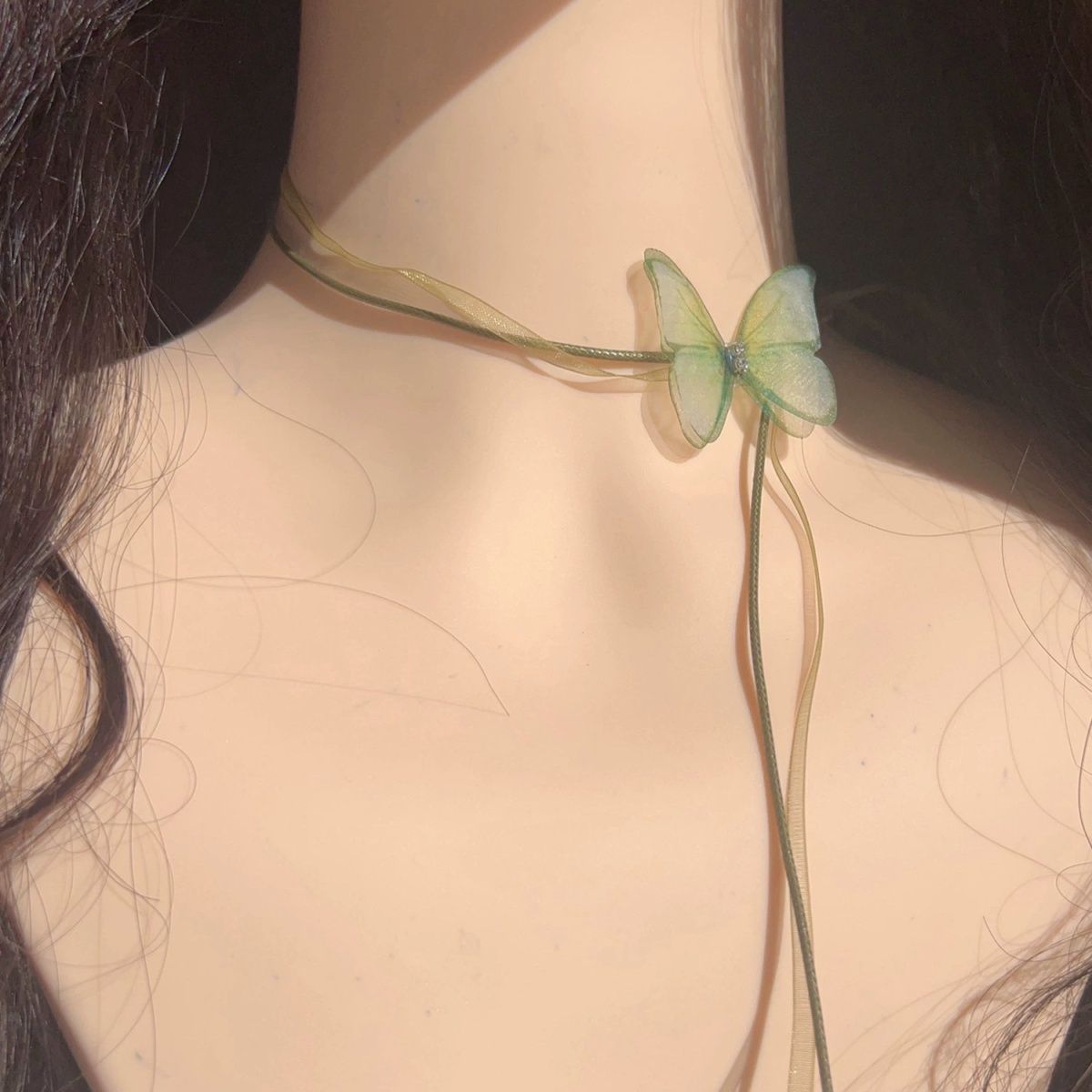 The choker is a unique and ethereal green chiffon butterfly long lace-up neckband with a chic look