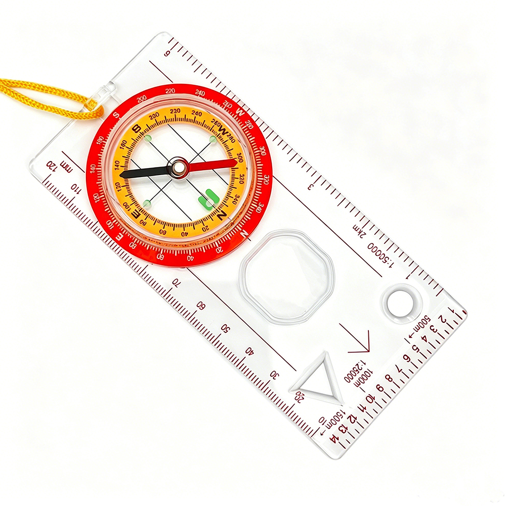 A transparent plastic compass with a red scale ring, a yellow steering wheel with a yellow lanyard and multi-scale scale lines
