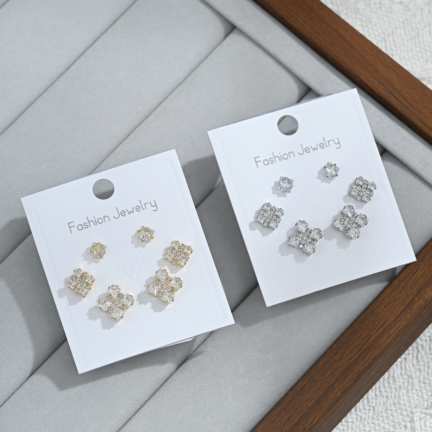 A new, unique and distinctive square white card with three pairs of earrings for daily use