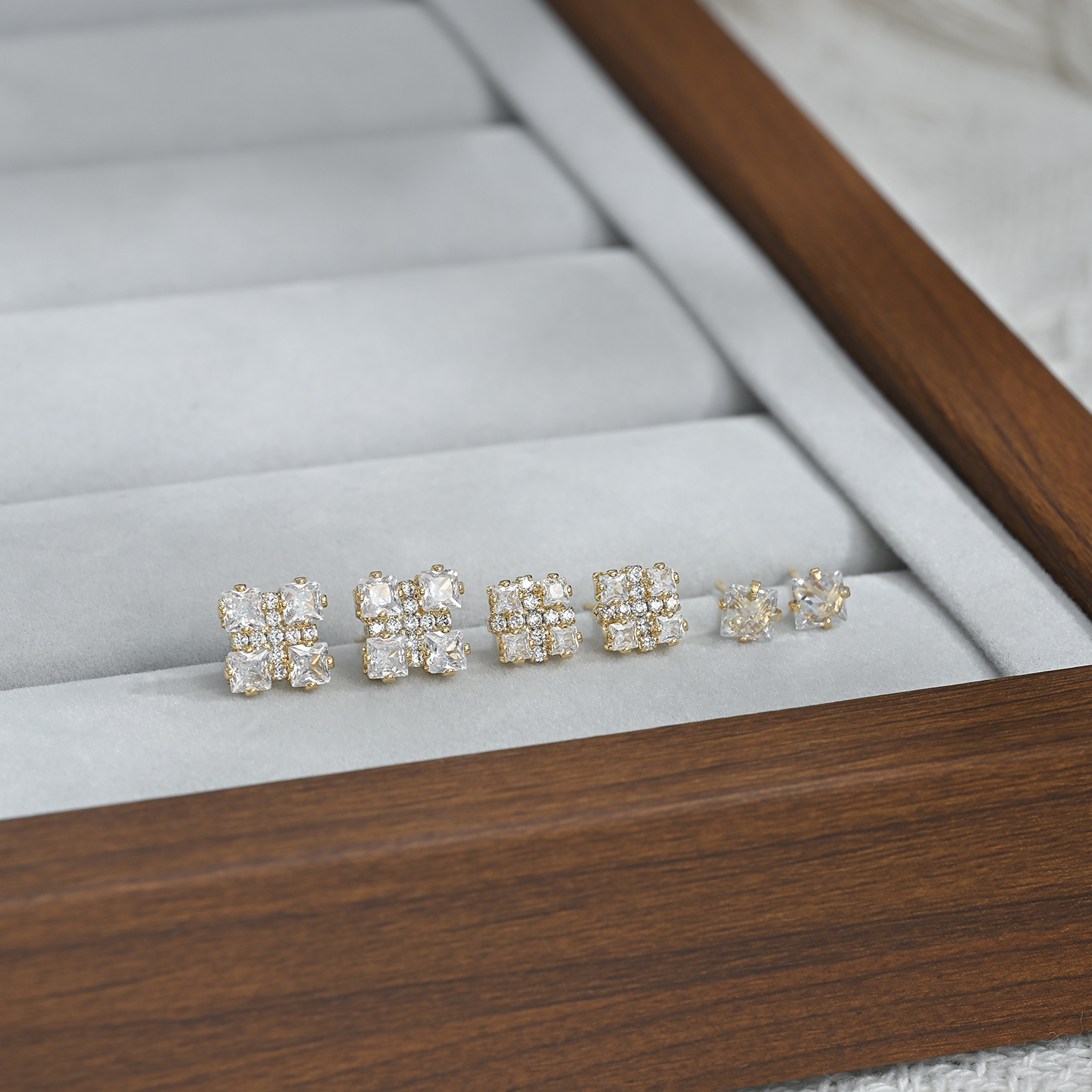A new, unique and distinctive square white card with three pairs of earrings for daily use details Picture