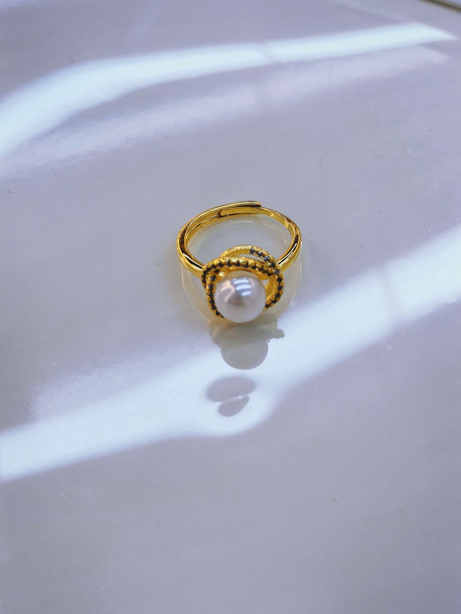 The golden pearl ring is a simple and elegant accessory for women