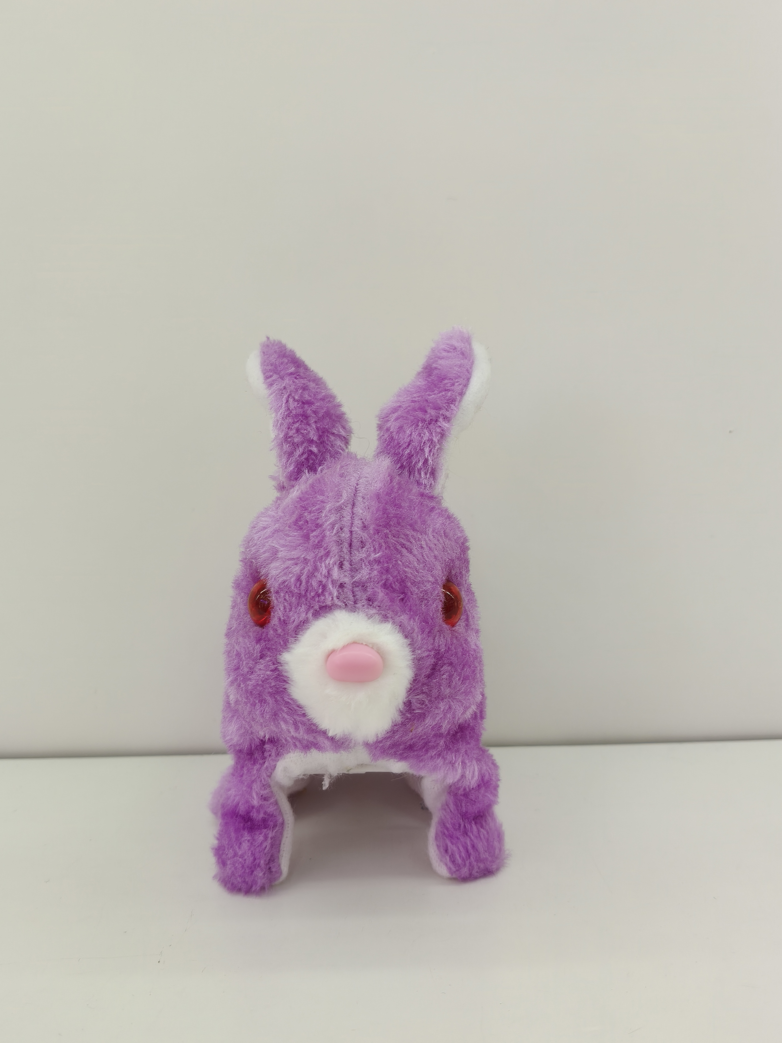The red-eyed colorful rabbit can walk, make sounds and has bright eyes. It's a plush toy of a colorful puppy, a cute puppy toy for children details Picture