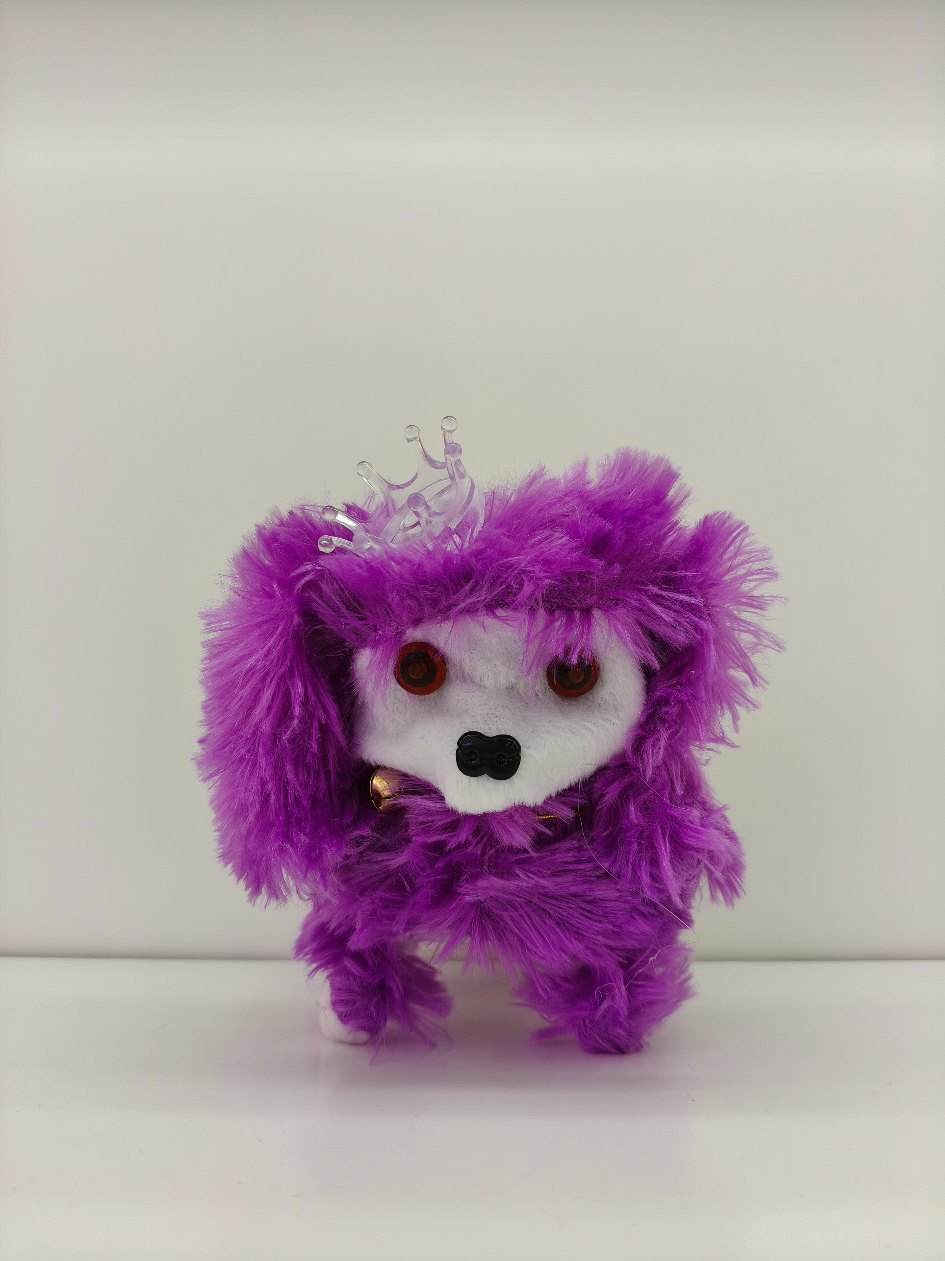 The Crown Dog can walk and bark. It has a crown on its head and is a cute multi-colored toy puppy Item Picture