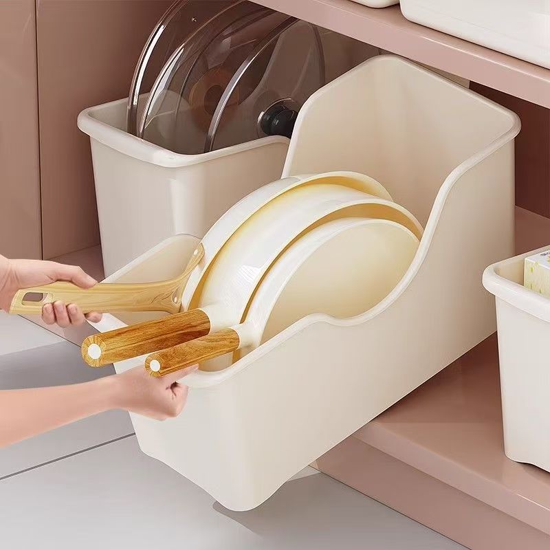 A off-white steel kitchen sink with a dish rack and a pot storage box
