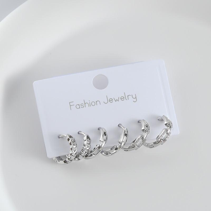 A popular, niche and simple one-card set of three pairs of gold and silver twisted ear studs, a must-have for cool girls in bars