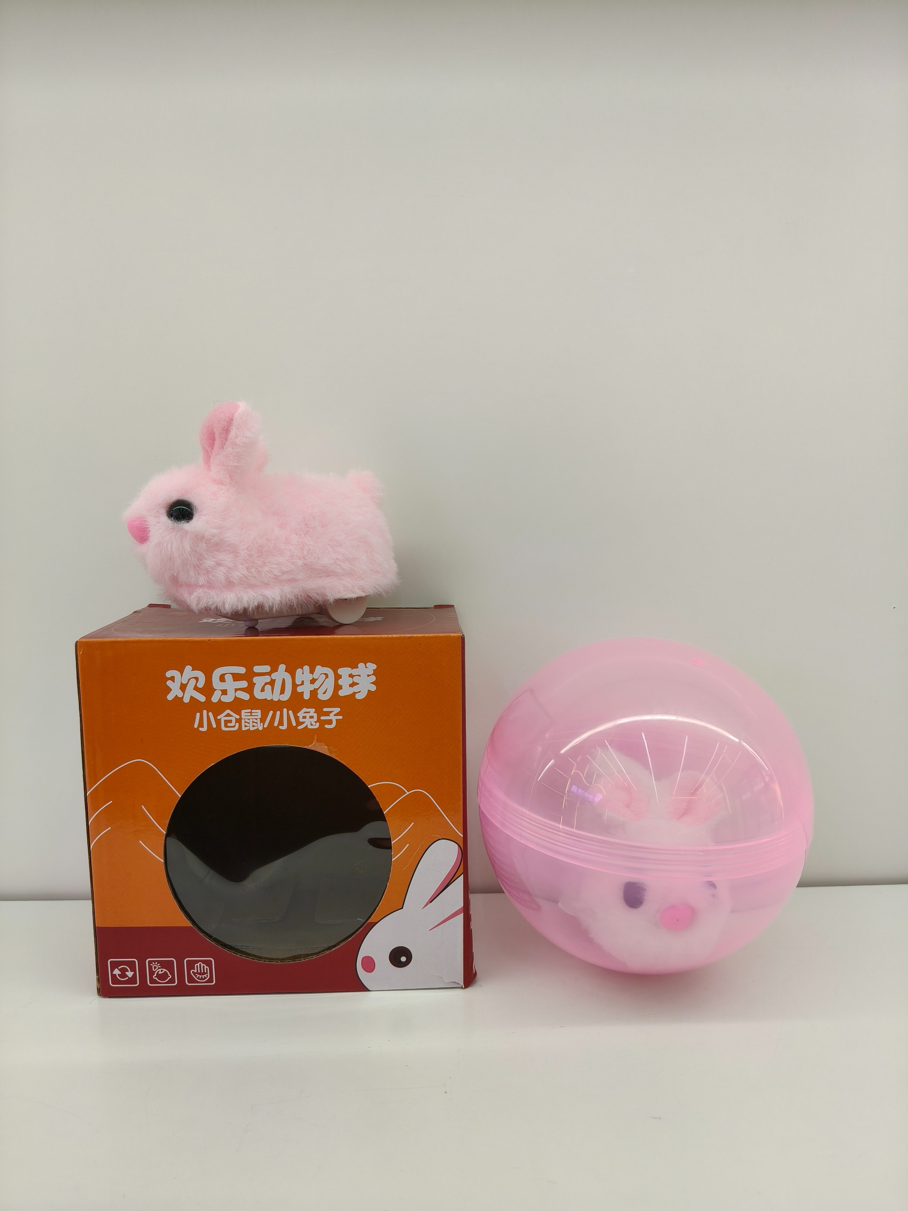 Pink transparent sphere, white plush rabbit, doll, claw toy, electric rabbit can run