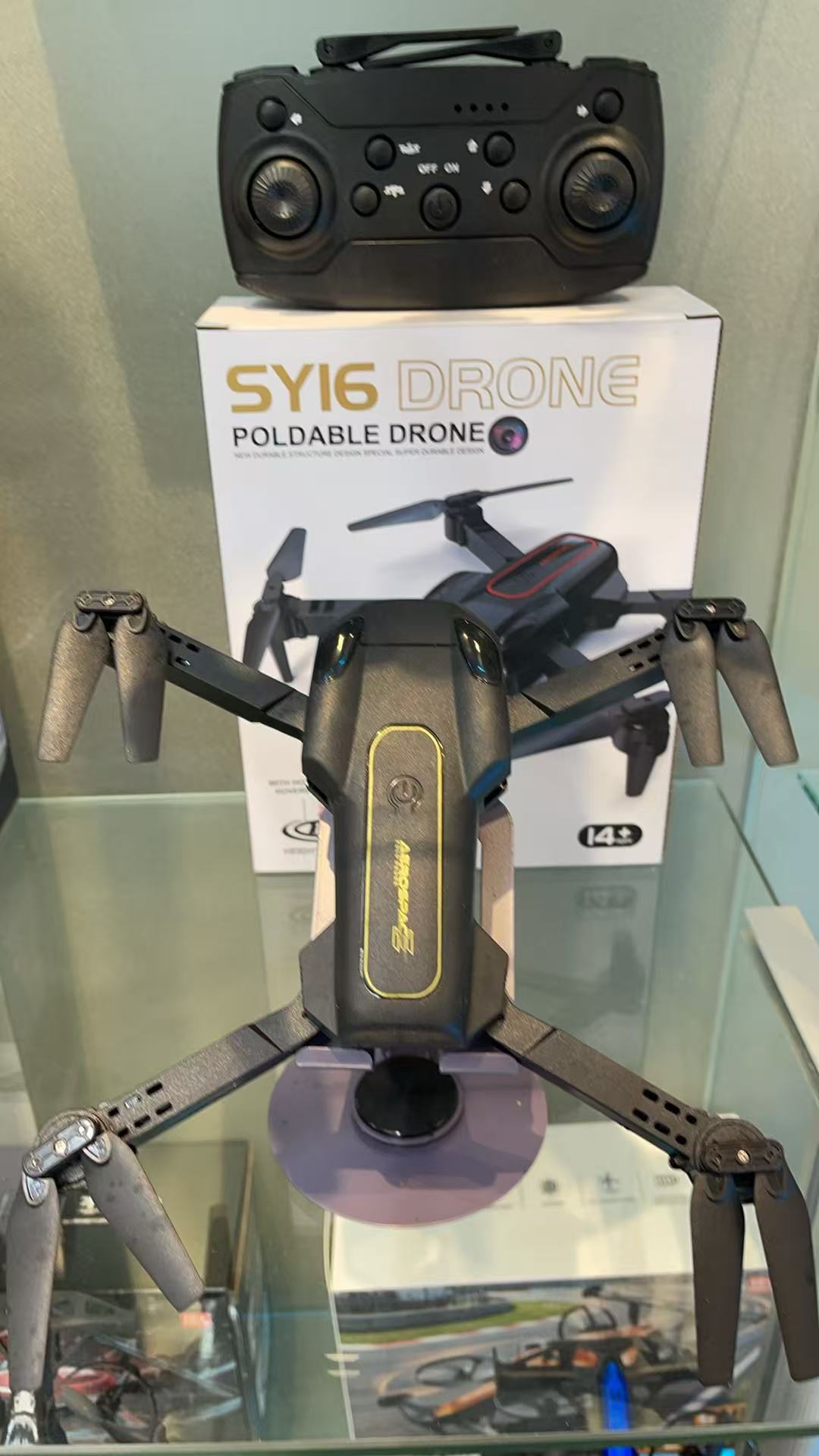 The SY16 black foldable drone is portable for aerial photography and can be carried around with an intelligent remote control screen display Specification image