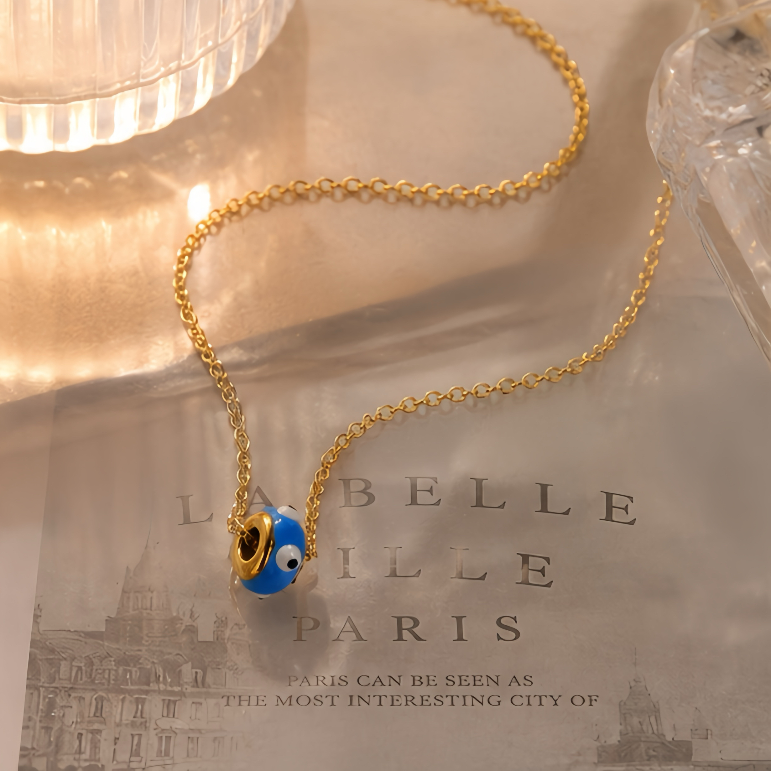 Blue background, big eyes, cartoon beads, stainless steel necklace, with a playful and quirky style for girls. It's a unique and eye-catching collarbone necklace that won't fade easily when worn daily Application Scenario