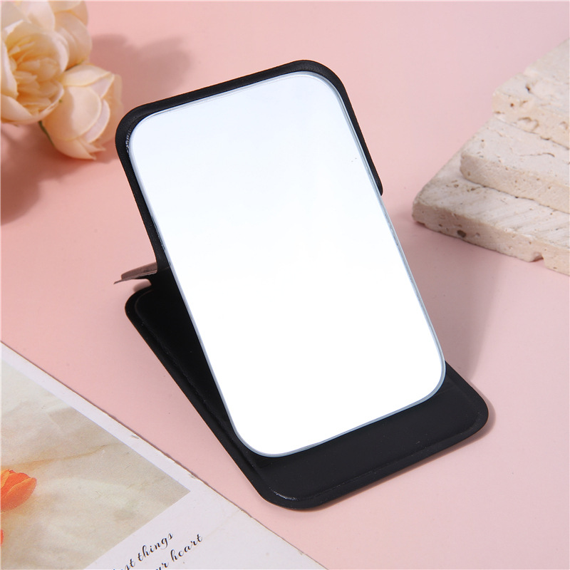 A portable small mirror for women, a simple desktop that can stand upright, ultra-mini student portable women's dressing and folding touch-up mirror undefined