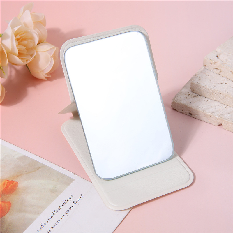 A portable small mirror for women, a simple desktop that can stand upright, ultra-mini student portable women's dressing and folding touch-up mirror undefined