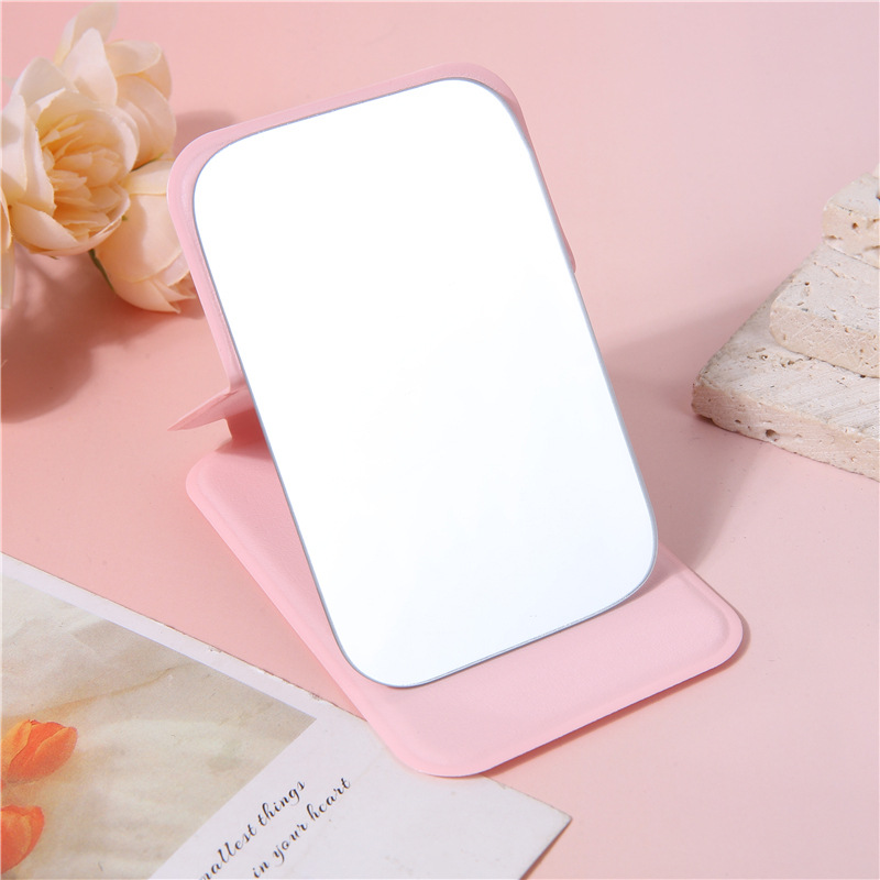 A portable small mirror for women, a simple desktop that can stand upright, ultra-mini student portable women's dressing and folding touch-up mirror undefined