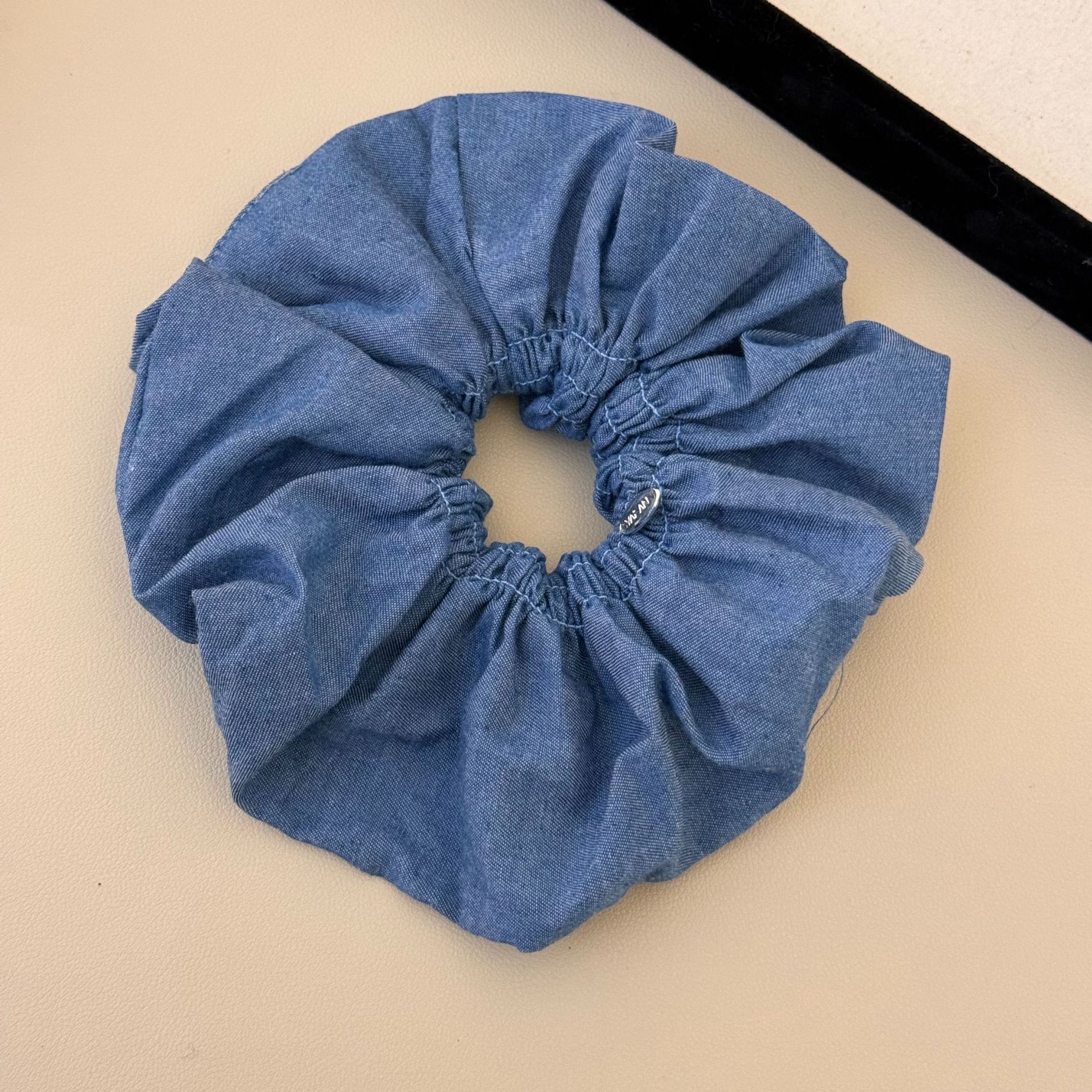A versatile and laid-back large denim ribbon bow hair band with a high-end and elegant style. It can be used as a hair tie and bun accessory for women undefined
