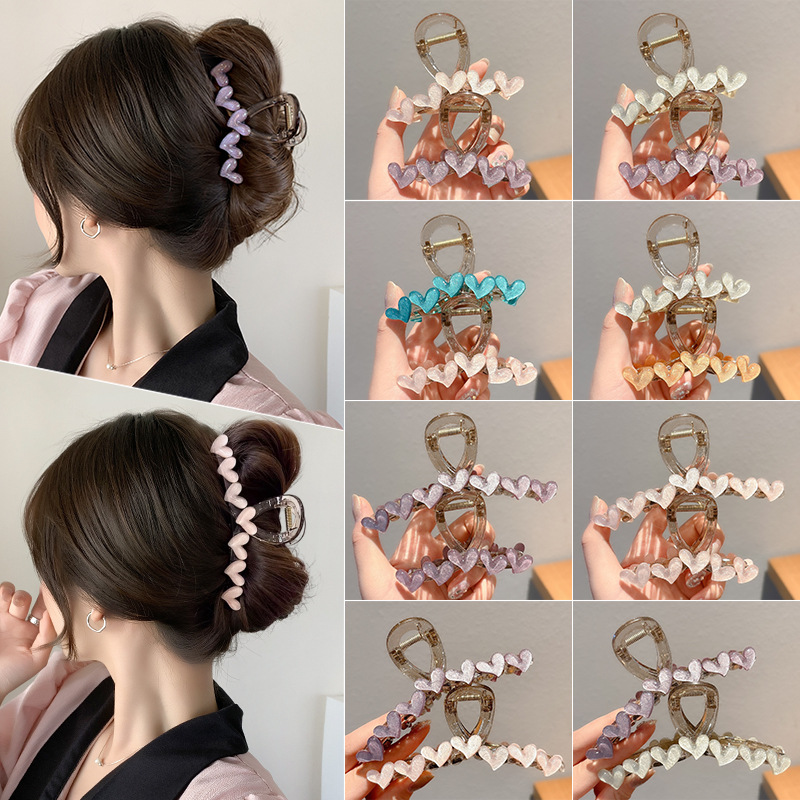 Simple jelly heart-shaped hairpin at the back of a woman's head, exuding a high-end and elegant charm. Shark clip, semi-tied hair accessory, hairpin full image