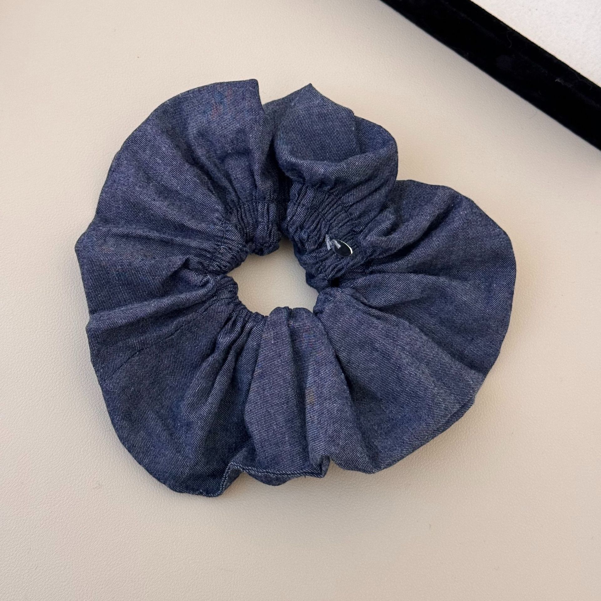 A versatile and laid-back large denim ribbon bow hair band with a high-end and elegant style. It can be used as a hair tie and bun accessory for women undefined