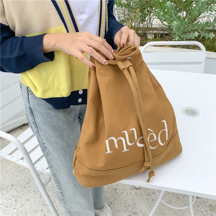 New Korean version backpack, simple letter printed canvas bag, hand-held large-capacity shopping bag, student bucket bag Application Scenario