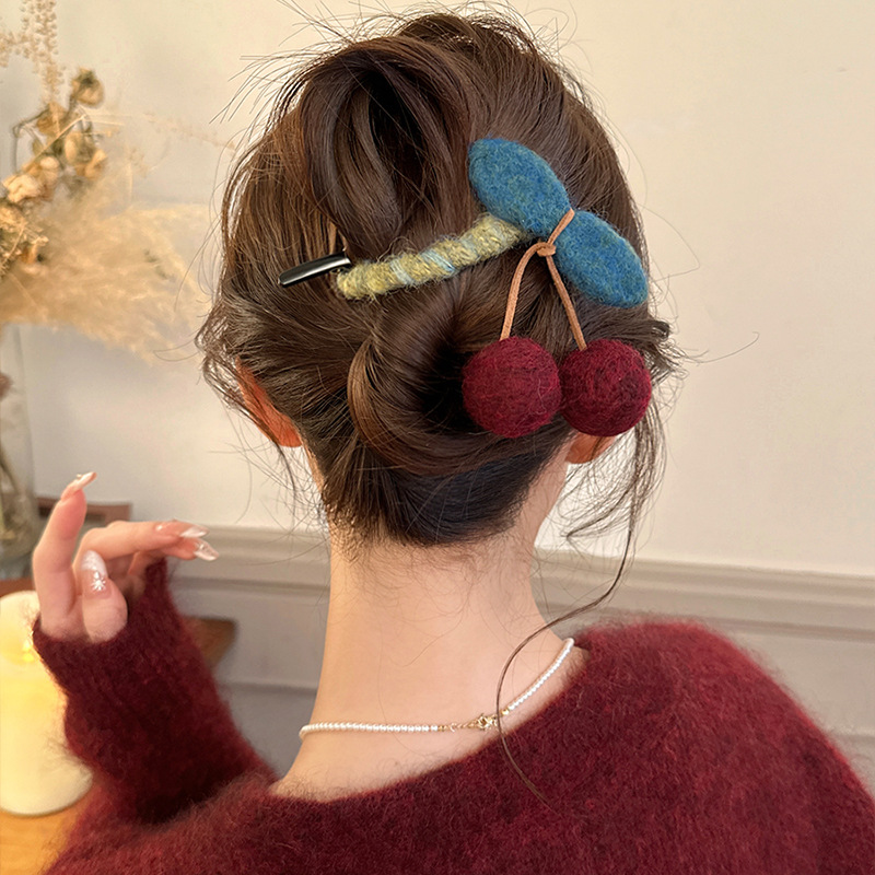 This autumn and winter retro cherry twist clip is a unique and high-end women's fashion hair clip. The back of the head is a shark clip that shows a lot of hair full image