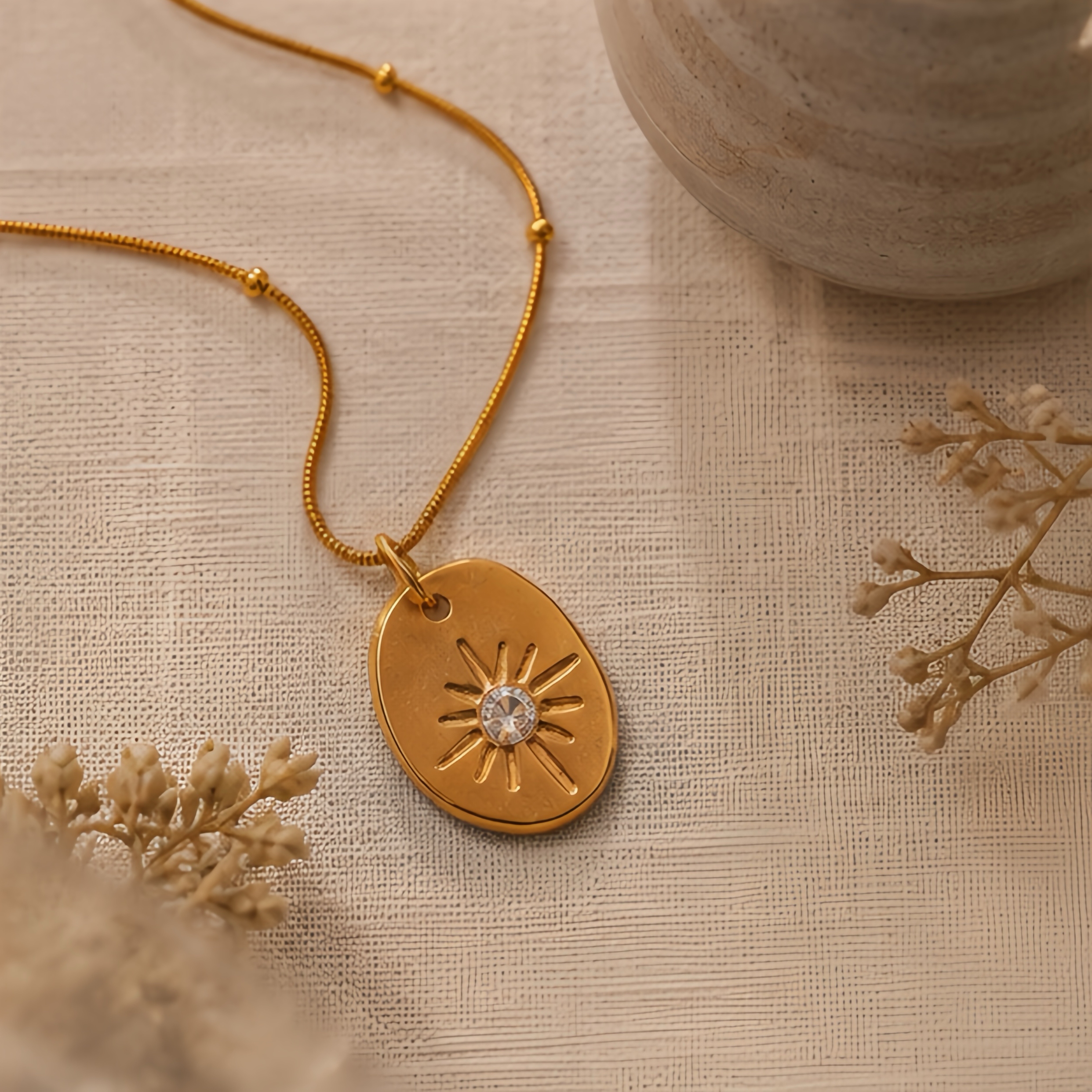 Irregular oval embossed sun pattern pendant, stainless steel snake bone chain, light luxury commuting outfit, simple Korean style, high-end collarbone neck accessory Application Scenario